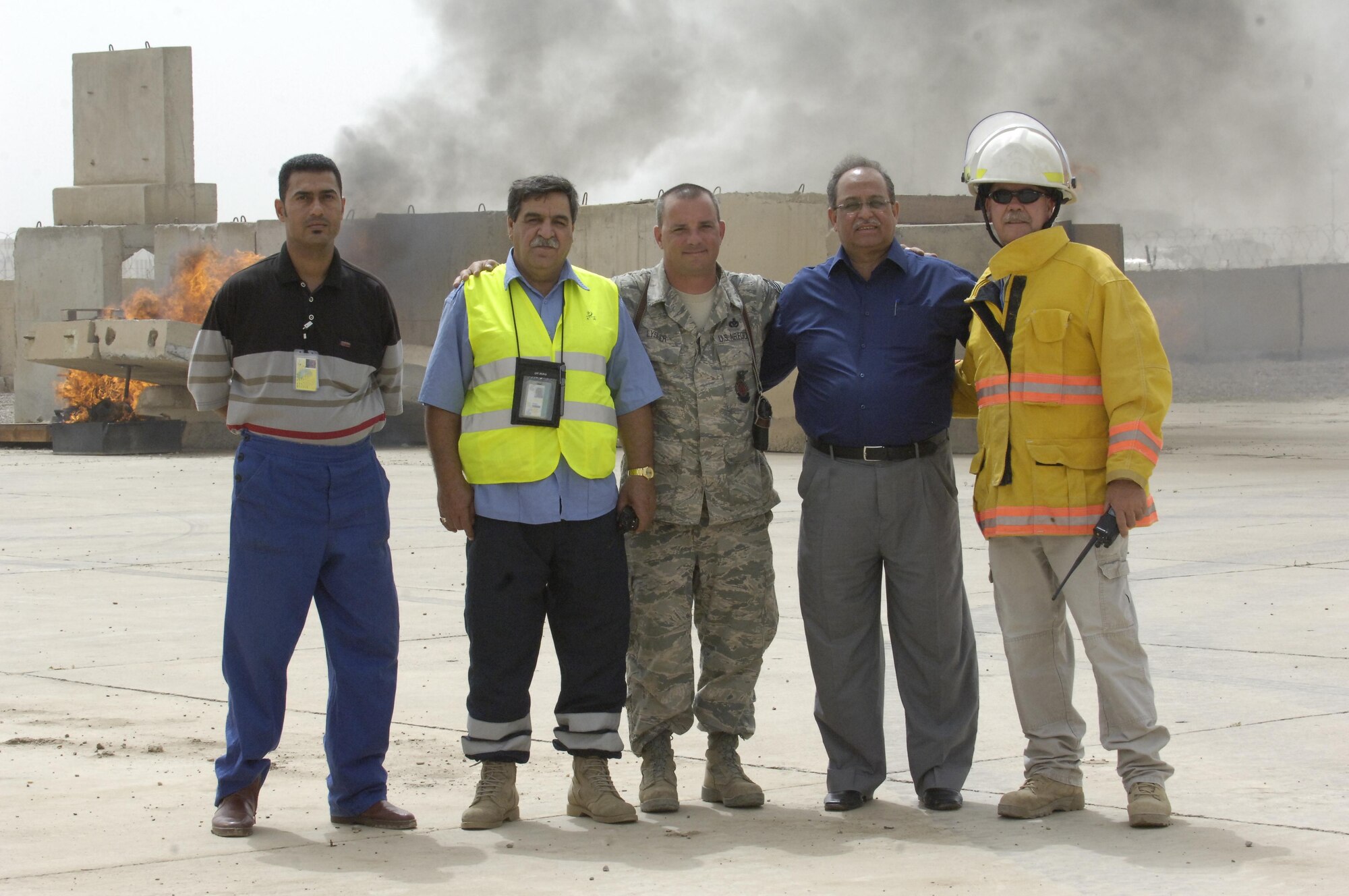 BAGHDAD – Chief Master Sgt. Daniel Lysher, 447th Expeditionary Civil Engineer Squadron Fire Emergency Services chief, center, pauses for a photo with the leadership from various firefighting agencies in front of the new aircraft fire fighting simulator at Baghdad International Airport May 18. The newly completed simulator is the culmination of efforts by multiple organizations and will be used to ensure military and civilian firefighters are able to complete annual training requirements. Also in the photo are (l to r) Jasem Hashoosh, BIAP firefighter, Mohammed Shunashal, BIAP Fire Department Shift 3 commander, Rafie Sahi, BIAP Fire Department deputy fire chief, and Chief Wayne Morrow, Sather Air Base fire chief. (U.S. Air Force photo by Tech. Sgt. Randy Redman)