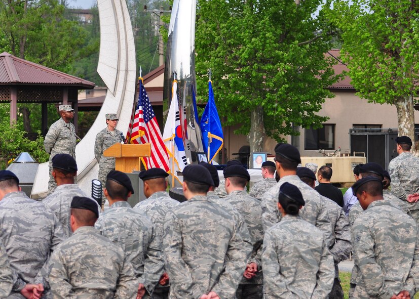 A joint formation stands near the memorial in front of Turumi Lodge here May 19, to honor fallen law enforement members during National Police Week. Osan members recently celebrated National Police Week with a weapons and vehicle display and free fingerprinting at the base exchange; a 5k fun-run; and a ceremonial retiring of two Airmen who were killed in the line of duty. (U.S. Air Force photo/Staff Sgt. Chad Thompson)