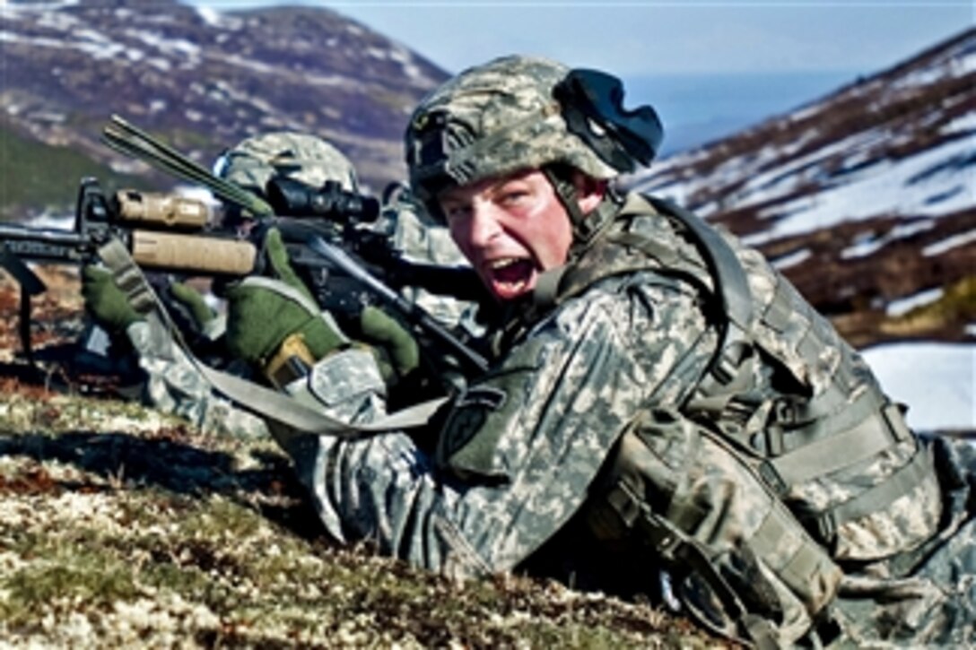 Army Sgt. 1st Class Kyle Silvernale yells commands to his troops during air assault training in Alaskaís Chugach Mountain Range on May 12, 2011.  Silvernale is assigned to Company C, 1st Battalion, 501st Infantry Regiment.  