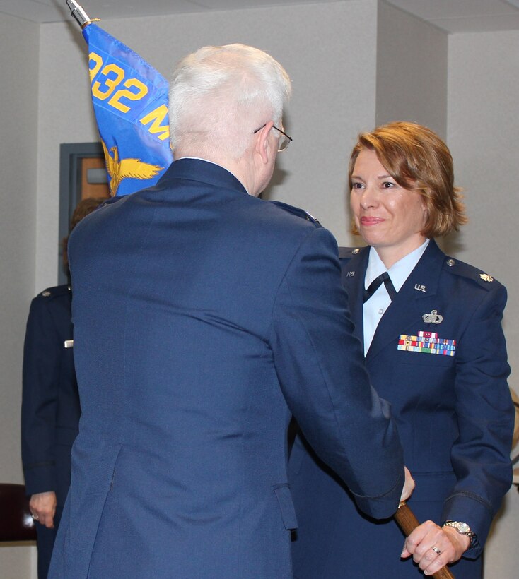 Lt. Col. Kathryn Russel recieves  the 932nd Force Support Squadron (FSS) flag from Col. Lynn Jobes, commander, of the 932nd Mission Support Group. Colonel Russell now commands the newly-formed 932nd FSS, which represents the merger of Services and the Military Personnel Flight.  Also, this marks Colonel Russel's third tour with the 932nd Airlift Wing.  (U.S. Air Force photo/Senior Airman Jessica Davila-Caba)