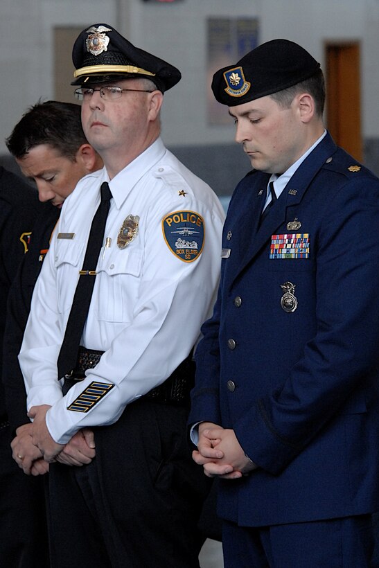 Maj. Steven Ohlmeyer, 28th Security Forces Squadron commander (right), and Box Elder Police Chief Timothy Ryan, Box Elder, S.D., pause for a moment of silence during the National Police Week 2011 remembrance ceremony in the Ellsworth Air Force Base, S.D. Pride Hangar, May 20, 2011. The names of all members of the law enforcement community killed in the line of duty between May 2010 and May 2011 were read during the ceremony. (U.S. Air Force photo by Master Sgt. Michael Morford)