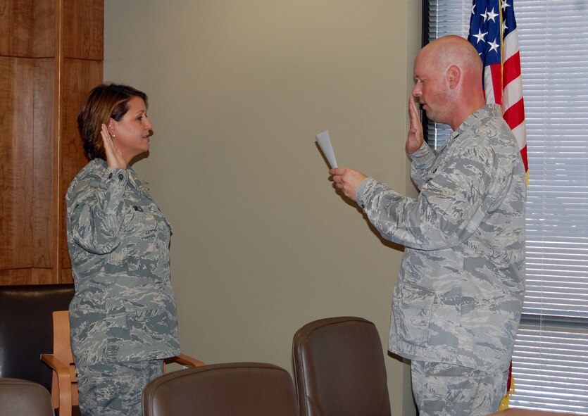 NELLIS AIR FORCE BASE -- (Left) 1st Lt. Dawn Streicher-Mills, 926th Aerospace Medicine Squadron, repeats the commissioning oath administered by Lt. Col. Travis Caughlin, here May 19. Lieutenant Streicher-Mills was recently commissioned under the U.S. Air Force Reserve Medical Service Corps Direct Commissioning Program. Formerly a master sergeant serving as a health services administrator in the 926th AMDS, she is now a medical services corps officer with the unit. Lieutenant Streicher-Mills has been a member of the 926th AMDS since July 2008. (U.S. Air Force photo/Staff Sgt. Laura Valenzuela)