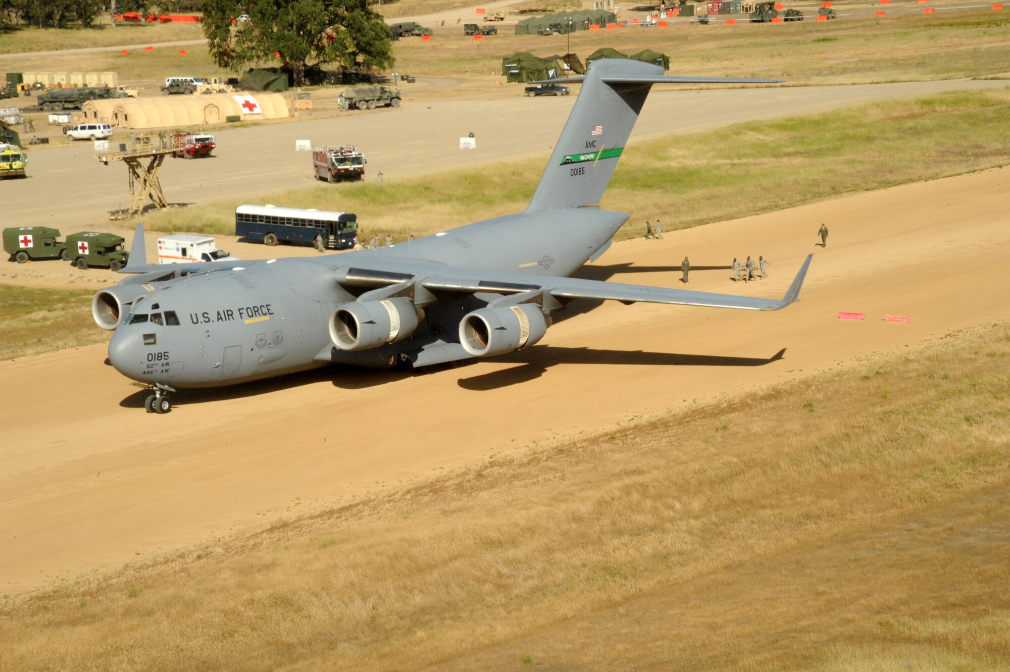 A U.S. Air Force C-17 Globemaster III from Joint Base Lewis-McChord, Wash., simulates a patient transfer with a U.S. Army UH-60 Blackhawk from the 2-238th Aviation, Victorville, Calif., at Fort Hunter Liggett, Calif., May 20, 2011, in support of Global Medic 2011 and Warrior 91 11-01. Warrior Exercise gives participating units an opportunity to rehearse military maneuvers and tactics such as security, convoy operations and quick reaction drills during simulated enemy attacks. Global Medic is a joint field training exercise for theater aeromedical evacuation system and ground medical components designed to replicate all aspects of combat medical service support. (U.S. Air Force photo by Tech. Sgt. Christine Jones/Released)