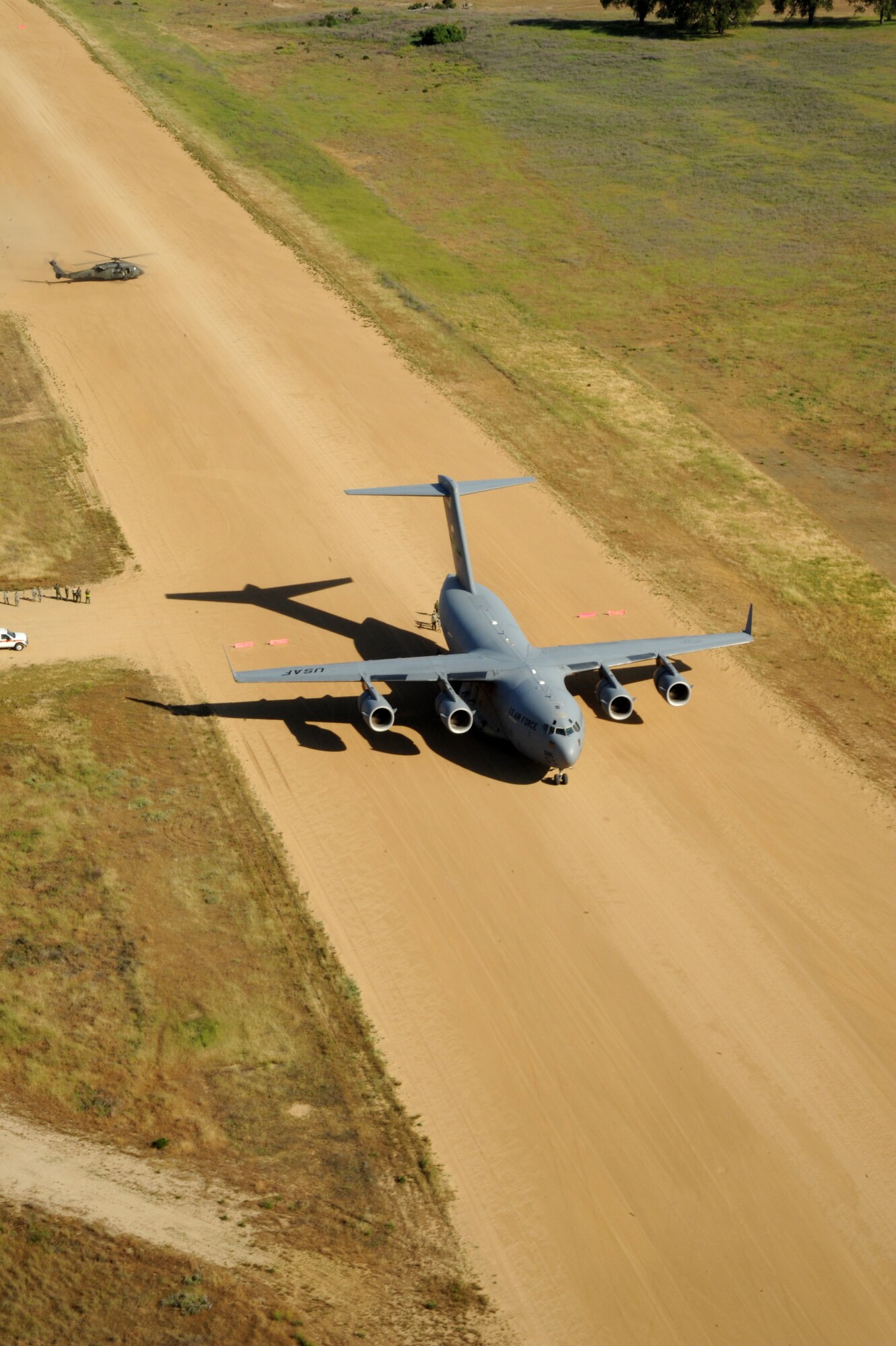 A U.S. Air Force C-17 Globemaster III from Joint Base Lewis-McChord, Wash., simulates a patient transfer with a U.S. Army UH-60 Blackhawk from the 2-238th Aviation, Victorville, Calif., at Fort Hunter Liggett, Calif., May 20, 2011, in support of Global Medic 2011 and Warrior 91 11-01. Warrior Exercise gives participating units an opportunity to rehearse military maneuvers and tactics such as security, convoy operations and quick reaction drills during simulated enemy attacks. Global Medic is a joint field training exercise for theater aeromedical evacuation system and ground medical components designed to replicate all aspects of combat medical service support. (U.S. Air Force photo by Tech. Sgt. Christine Jones/Released)