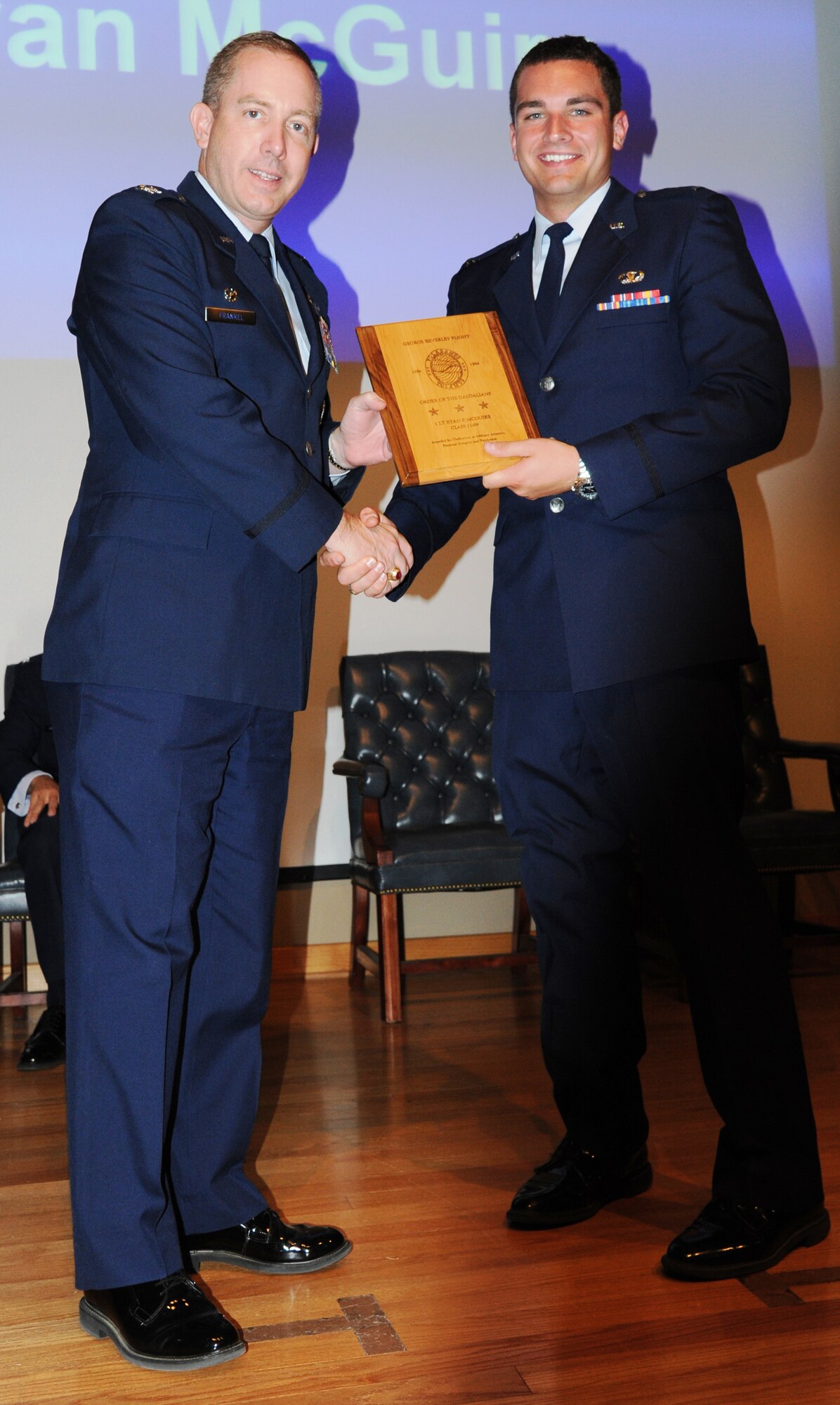 LAUGHLIN AIR FORCE BASE, Texas – First Lt. Ryan McGuire, 47th Operations Support Squadron, accepts the Daedalian Award from Col. Michael Frankel, 47th Flying Training Wing commander, during the graduation of Specialized Undergraduate Pilot Training class 11-09 at Laughlin’s Anderson Hall May 20. Lieutenant McGuire became the first person in the history of the Air Force to graduate pilot training as an amputee. (U.S. Air Force photo by Airman 1st Class Blake Mize)