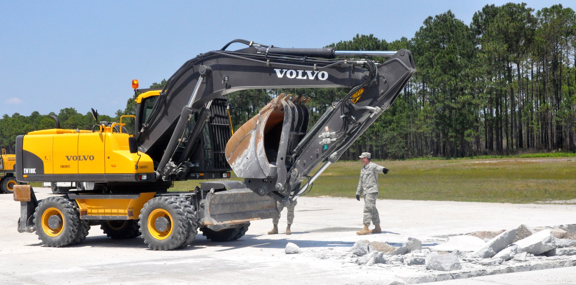 U.S. Air Force Staff Sgt. Garett Wass from the 446th Civil Engineer Squadron, McChord Field, Wash., directs excavator traffic during a field exercise to repair runway damage at Tyndall Air Force Base, Fla. on March 23, 2011. Sergeant Wass, a native of Bellingham, Wash., is one of 30 Reservists from the 446th CES participating in Silver Flag 2011, a training exercise designed to improve the readiness capability of Air Force civil engineers. (U.S. Air Force photo by Staff Sgt. Grant Saylor/Released)