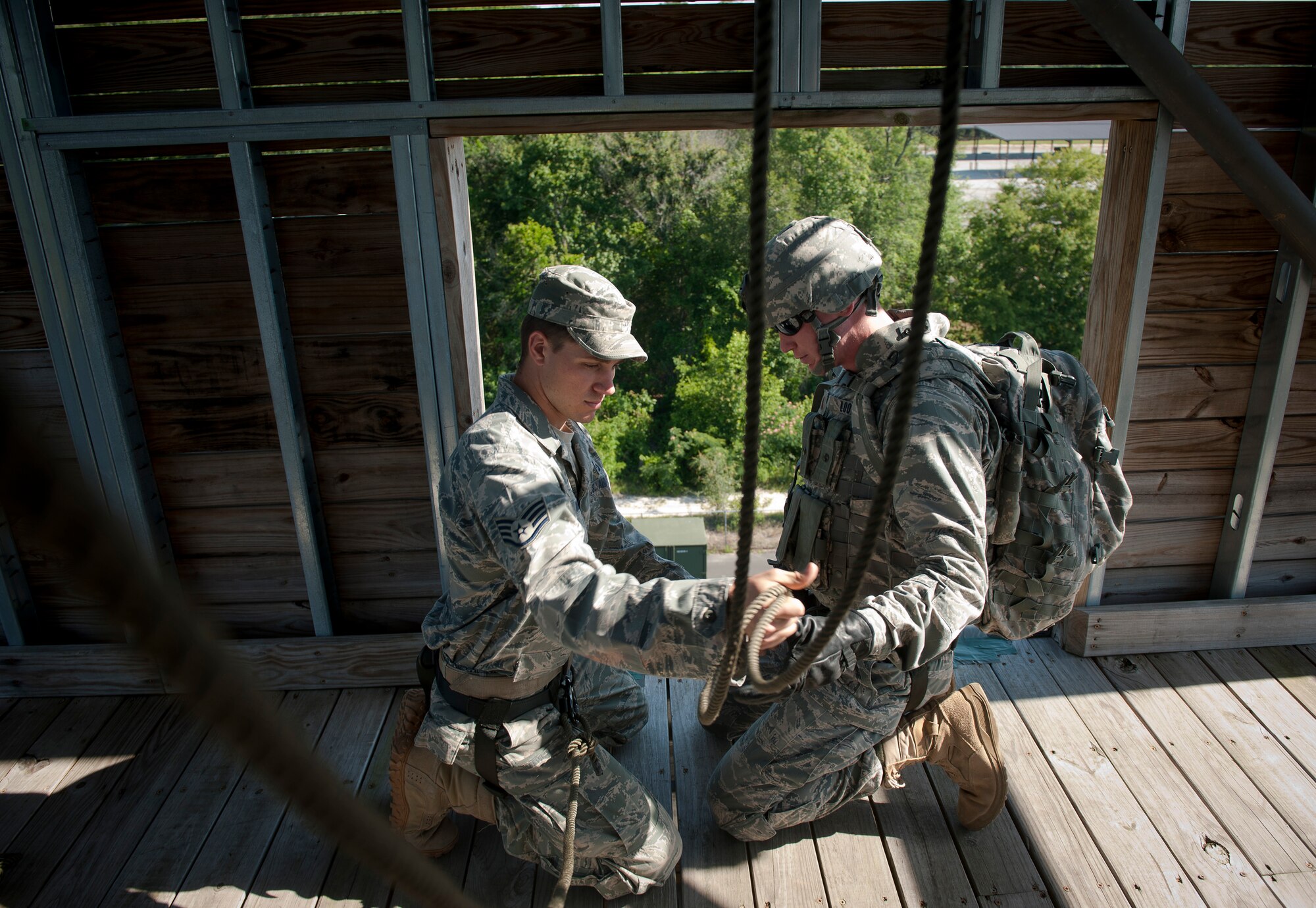 MOODY AIR FORCE BASE, Ga.-- Staff Sgt. Dallas Bozeman, 23rd Civil Engineer Squadron explosive ordnance disposal craftsman, hooks ropes onto 2nd Lt. Joshua Loomis, 820th Combat Operation Squadron during a repelling demonstration and base visit May 19. The 820th BDG Airmen displayed repel and fast ropes techniques providing a firsthand look at the type of training performed within the current partnership between the 820th Base Defense Group and 105th SFS, stationed in Stewart Air National Guard Base, N.Y. (U.S. Air Force photo/Airman 1st Class Joshua Green)(RELEASED)            
  
   
     
