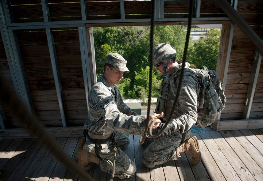 MOODY AIR FORCE BASE, Ga.-- Staff Sgt. Dallas Bozeman, 23rd Civil Engineer Squadron explosive ordnance disposal craftsman, hooks ropes onto 2nd Lt. Joshua Loomis, 820th Combat Operation Squadron during a repelling demonstration and base visit May 19. The 820th BDG Airmen displayed repel and fast ropes techniques providing a firsthand look at the type of training performed within the current partnership between the 820th Base Defense Group and 105th SFS, stationed in Stewart Air National Guard Base, N.Y. (U.S. Air Force photo/Airman 1st Class Joshua Green)(RELEASED)            
  
   
     
