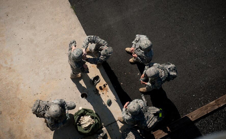 MOODY AIR FORCE BASE, Ga.-- Airmen from the 820th Base Defense Group place gear on an Airmen who prepared to repel during a demonstration May 19. Proper safety and protection were main points during the demonstration. (U.S. Air Force photo/Airman 1st Class Joshua Green)(RELEASED)           
   
     
