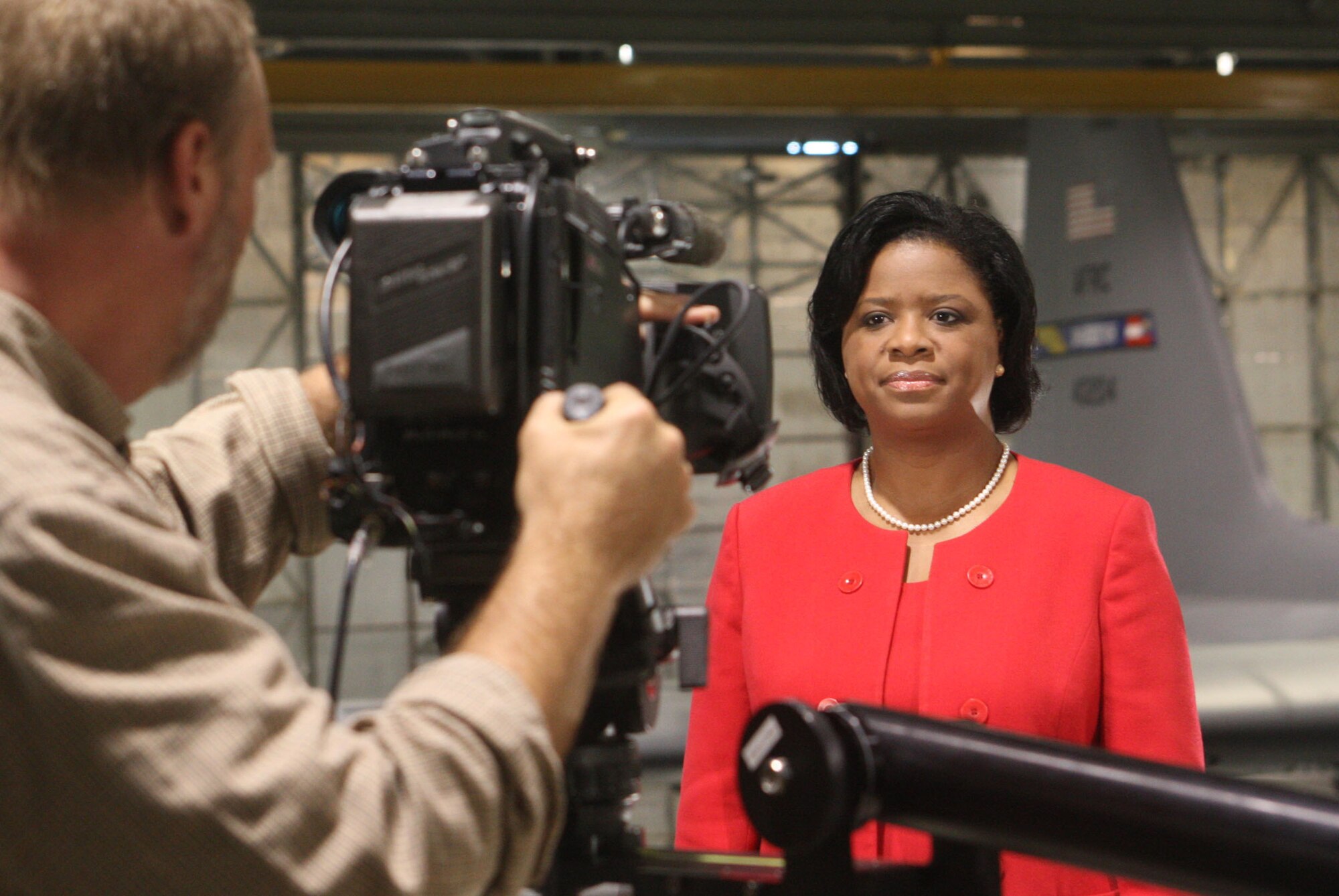Shan Cooper, Lockheed Martin Vice President and General Manager, Marietta, Ga. plant prepares to record a segment of her monthly employee newscast "Shans Minute" from the maintenance section bay three here Mar 23. (U.S. Air Force Photo/Don Peek)