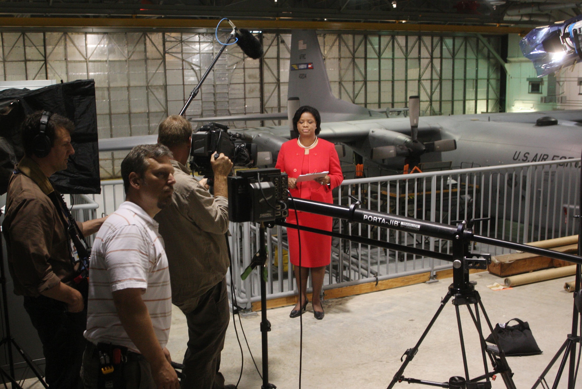 The crew from Lockheed Martins video team prepares to capture footage of Shan Cooper, Lockheed Martin vice president and general manager in the Marietta, Ga. plant, as she records a segment for her monthly employee’s newscast "Shans Minute" here in bay three maintenance section Mar 23. (U.S. Air Force Photo/Don Peek) 