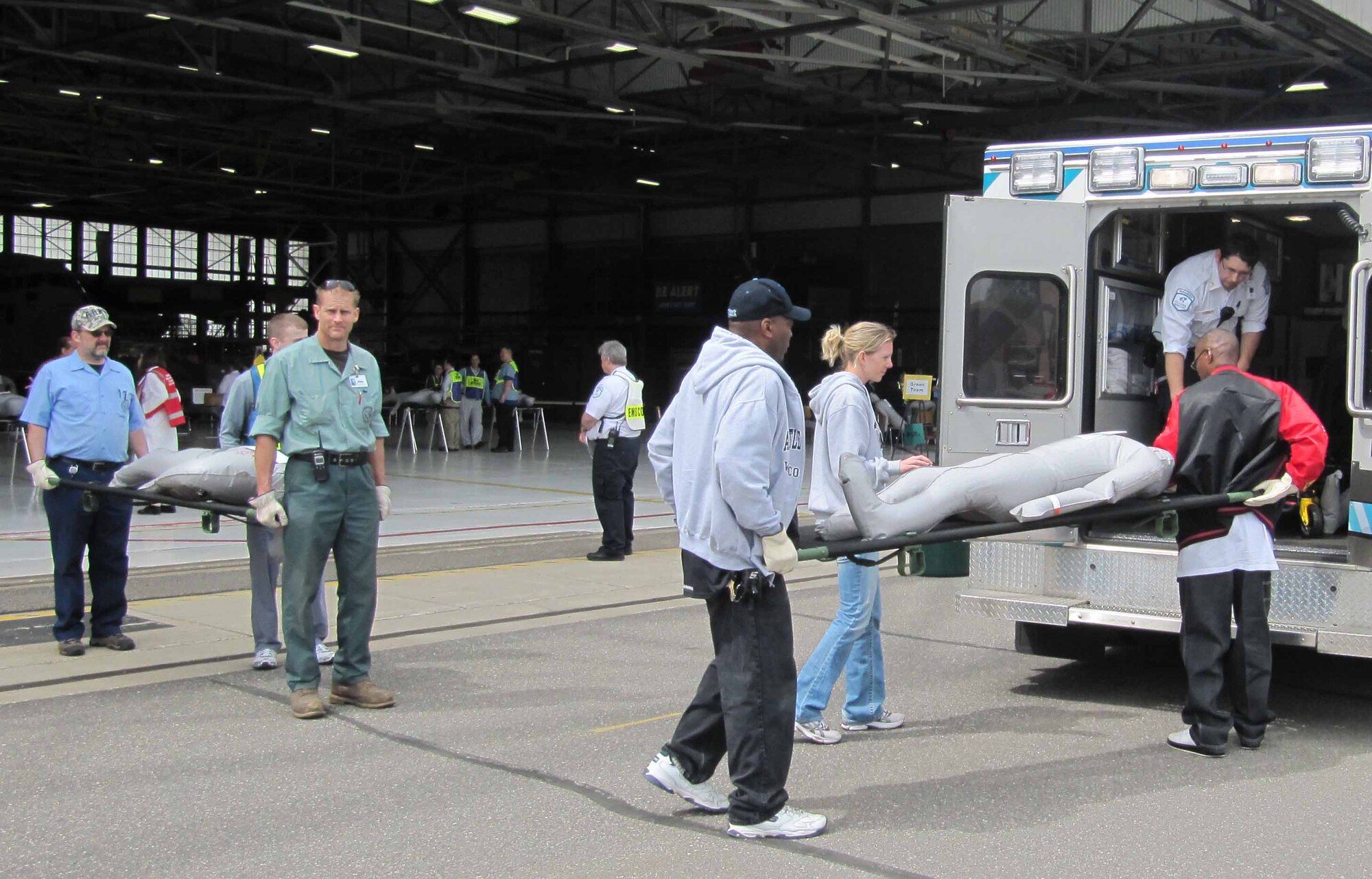 Representatives from local health care and government agencies transport simulated patients during the patient processing portion of the National Exercise Argent Sentry May 19th at the 934th Airlift Wing. The exercise centered on the scenario of a catastrophic earthquake encompassing eight central states. (Air Force Photo/Lt. Col. C.J. Bentley)