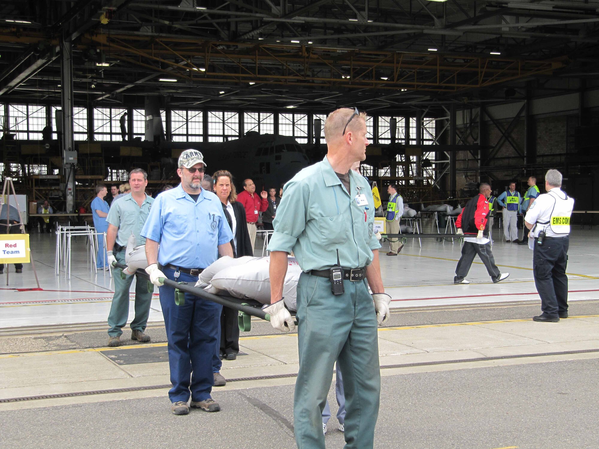 Representatives from local health care and government agencies transport simulated patients during the patient processing portion of the National Exercise Argent Sentry May 19th at the 934th Airlift Wing. The exercise centered on the scenario of a catastrophic earthquake encompassing eight central states. (Air Force Photo/Lt. Col. C.J. Bentley)