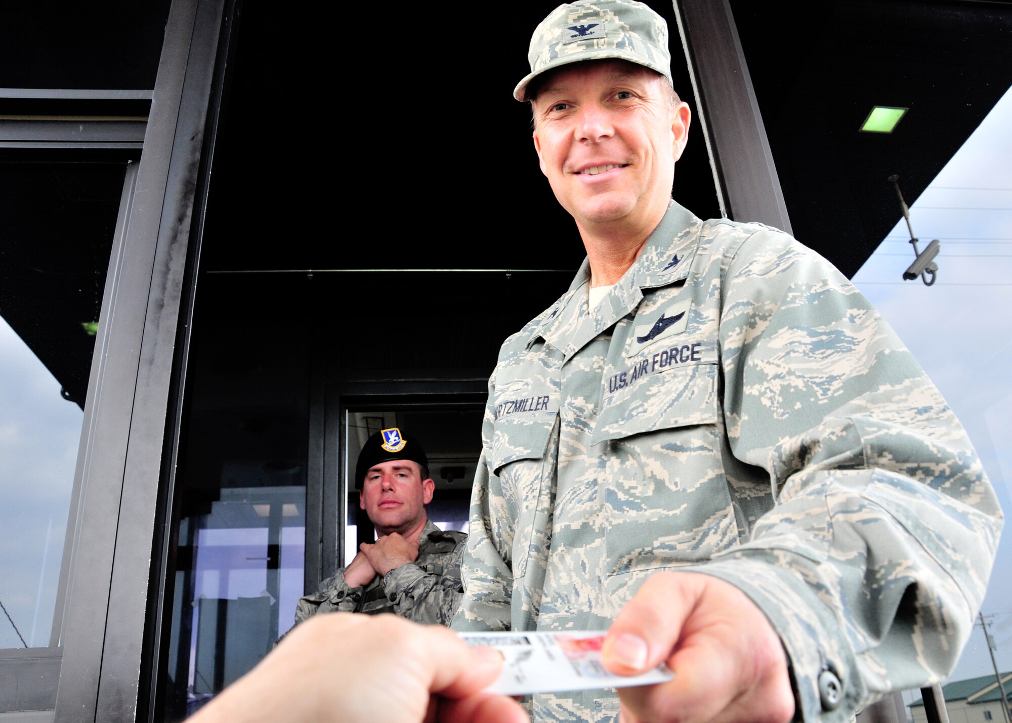 As part of National Police Week 914th Airlift Wing Commander Col. Allan L. Swartzmiller checks ID cards at the Niagara Falls Air Reserve Stations front gate, May 13, 2011, Niagara Falls, NY. Established by a joint resolution of Congress in 1962, National Police Week pays special recognition to those law enforcement officers who have lost their lives in the line of duty for the safety and protection of others. (U.S. Air Force photo by Staff Sgt. Joseph McKee)