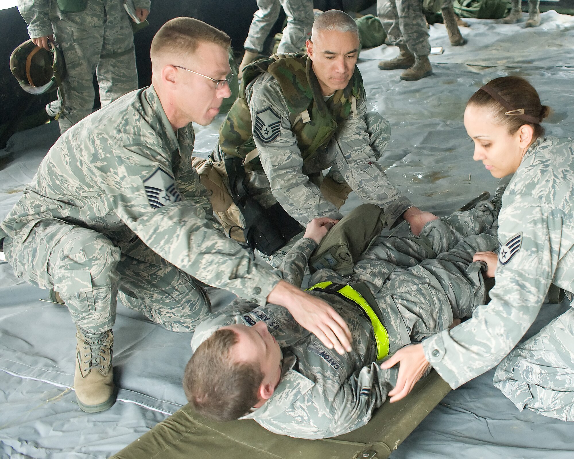 Self Aid and Buddy Care instructors demonstrate how to properly roll a
casualty onto a field stretcher during a deployment exercise May 20, 2011, at
Dover Air Force Base, Del. When deployed Self Aid and Buddy Care has proven to be a life saver. (U.S. Air Force photo by Adrian Rowan)