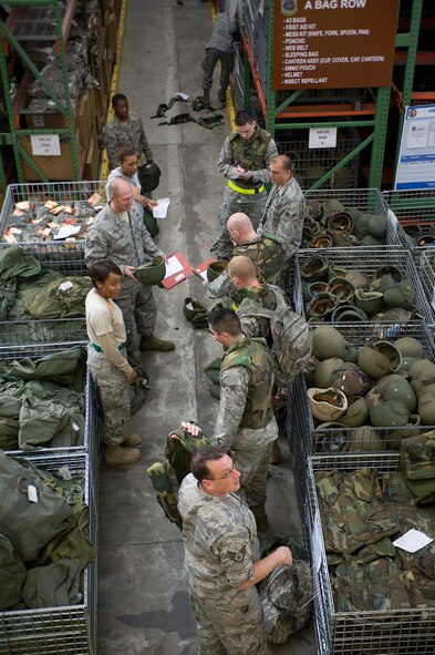 Members of Team Dover receive gear for an upcoming deployment exercise, May 20, 2011, at Dover Air Force Base, Del. The exercise trained servicemembers in many aspects of a deployment. (U.S. Air Force photo by Steve Kotecki)