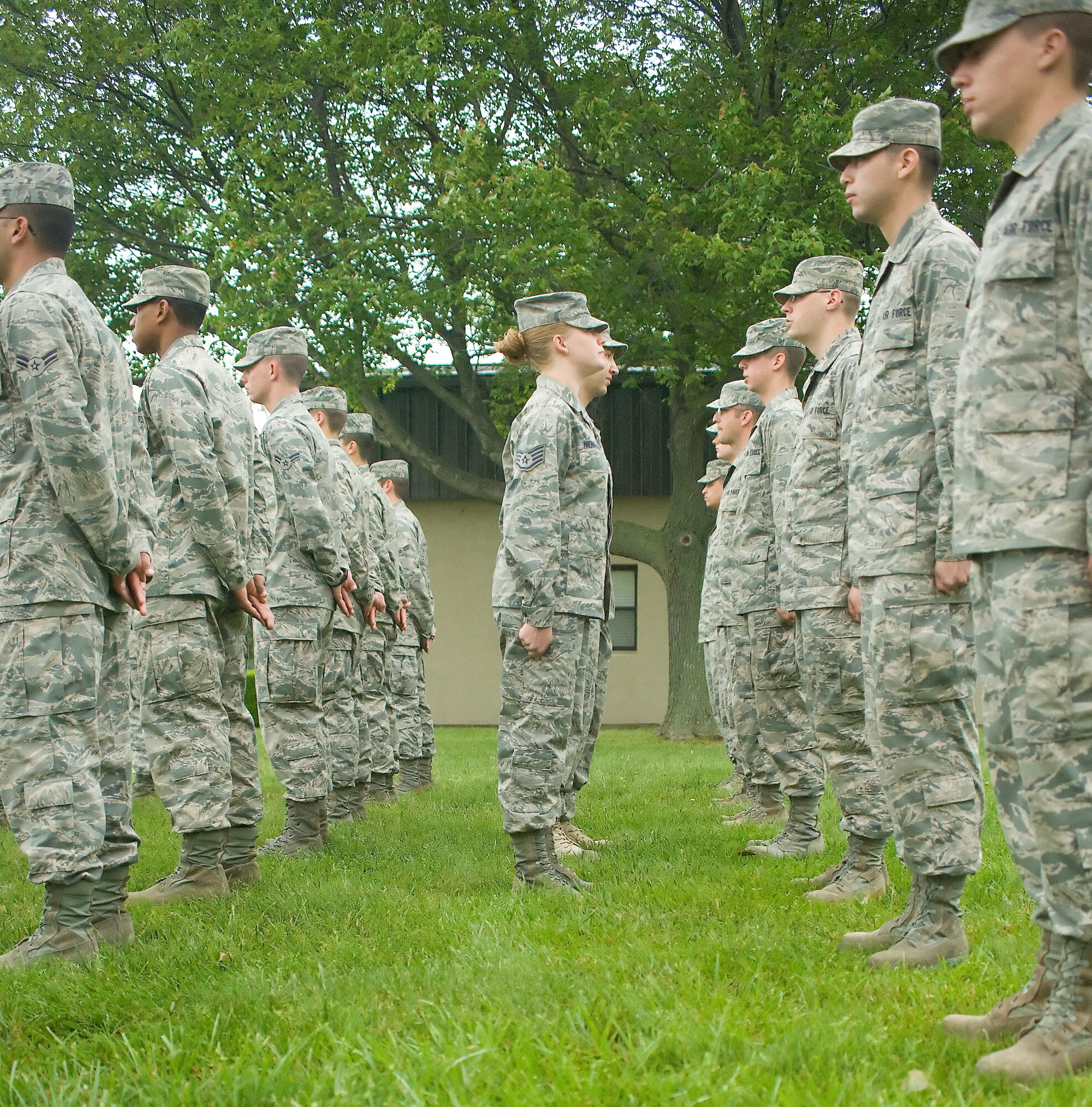 Staff Sgt. Jessica Nienhueser (center), and Staff Sgt. Ali Bueshi, 373rd Training Squadron military training leaders, inspect Detachment 3 Airmen’s appearances May 24, 2011, at Dover Air Force Base, Del. The MTLs assure that Airmen in training retain the standards and discipline taught to them during Basic Military Training. (U.S. Air Force photo by Adrian Rowan)

