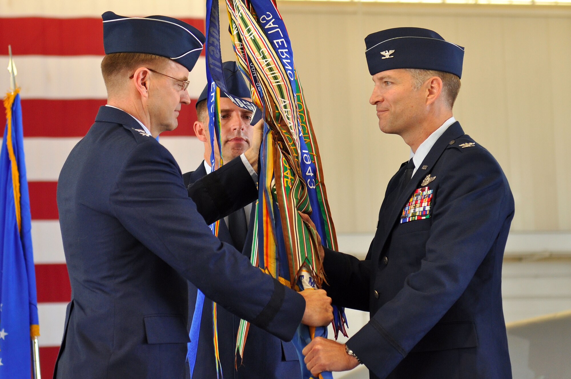 Maj. Gen. Stephen L. Hoog, 9th Air Force commander, passes the guidon to Col. Kevin J. Robbins during the 1st Fighter Wing change-of-command ceremony at Langley Air Force Base, Va., May 23, 2011. Colonel Robbins assumed command of the wing from Col. Matthew Molloy. (U.S. Air Force photo by Tech. Sgt. Christina M. Styer)(RELEASED) 