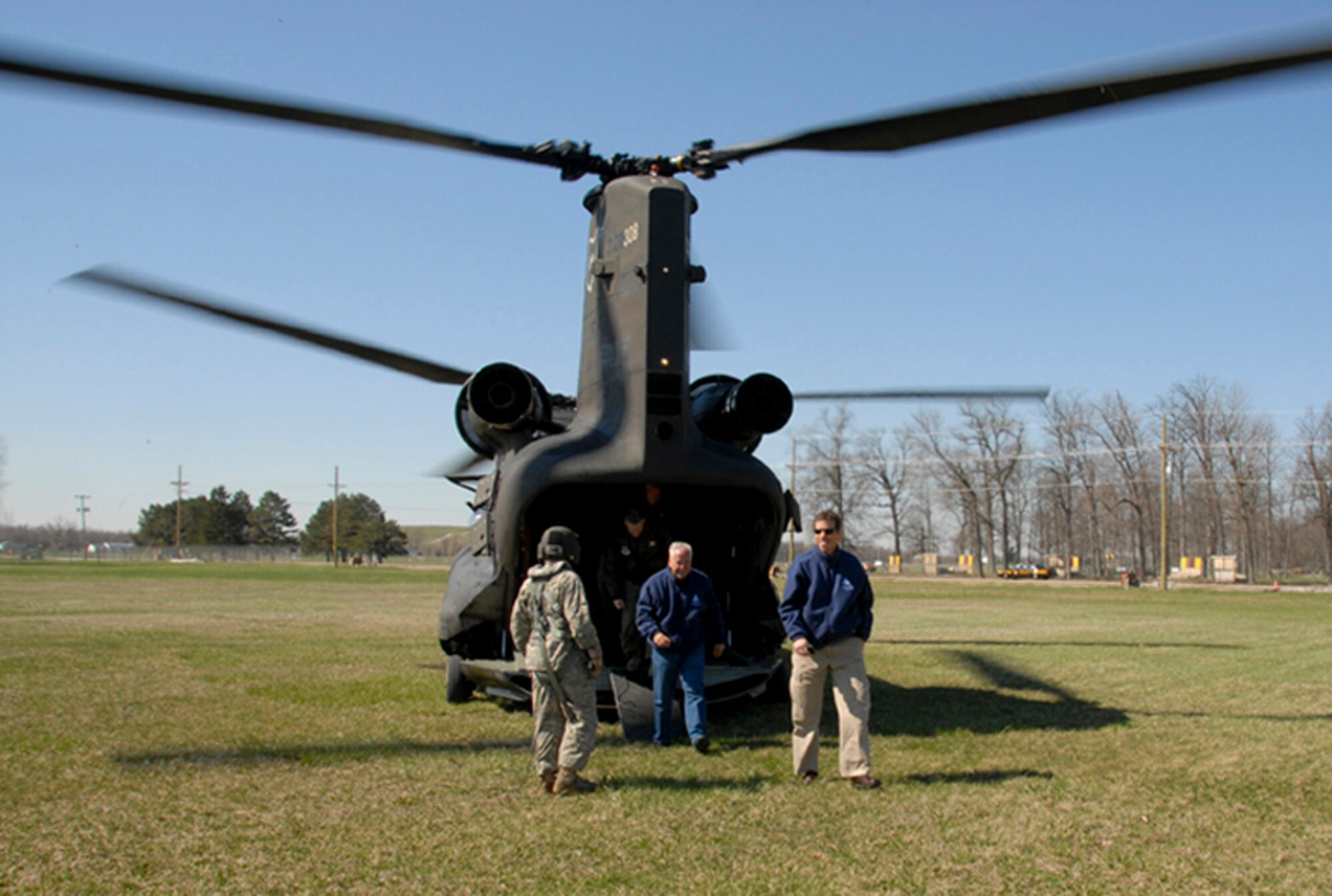 Members of the Young Presidents' Organization disembark from a Chinook helicopterat Camp Perry, in Port Clinton, Ohio, May 13, 2011. The YPO spent the day learning about the missions and leadership that make up the Ohio National Guard.