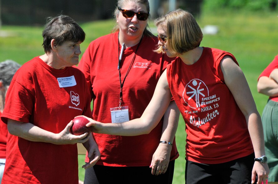 1st Lt. Rachael Clark, right, gets an athlete prepared for her turn at bocce during The 2011 Area #13 Special Olympics Summer Games April 29 at Tullahoma High School. Arnold Engineering Development Center's (AEDC) 43 volunteers assisted athletes in the games, along with more than 250 other volunteers from five area counties. More than 275 athletes participated in this year's track & field and bocce events. (Photo by Rick Goodfriend)