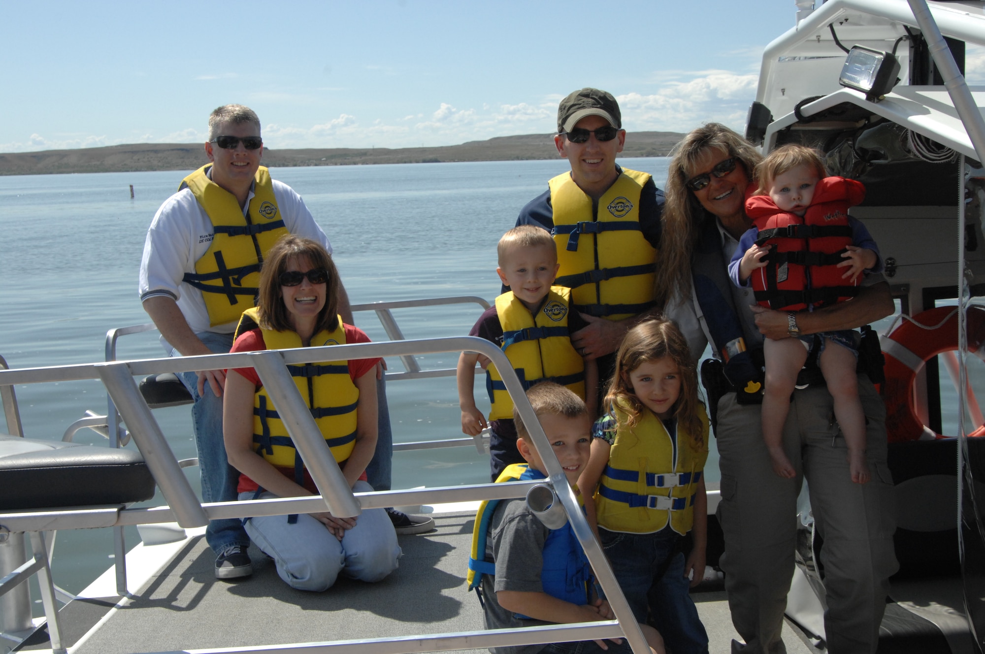 MOUNTAIN HOME AIR FORCE BASE, Idaho – 2nd Lt. David Liapis, 366th Fighter Wing Public Affairs chief of strategic communications, and his children, along with Lt. Col. Michal D. Holliday, 366th Civil Engineering Squadron commander, and his wife Kelly, prepare to receive a boat ride on the C.J. Strike Reservoir from Elmore County Sherriff’s Department Marine Deputy Laytreda Schultz May 21. The Elmore County Sherriff’s Department was present at the ribbon cutting ceremony for the grand opening of the new main marina facility built by 366th Fighter Wing Civil Engineer Squadron personnel. (U.S. Air Force photo by Senior Airman Benjamin Sutton.)
