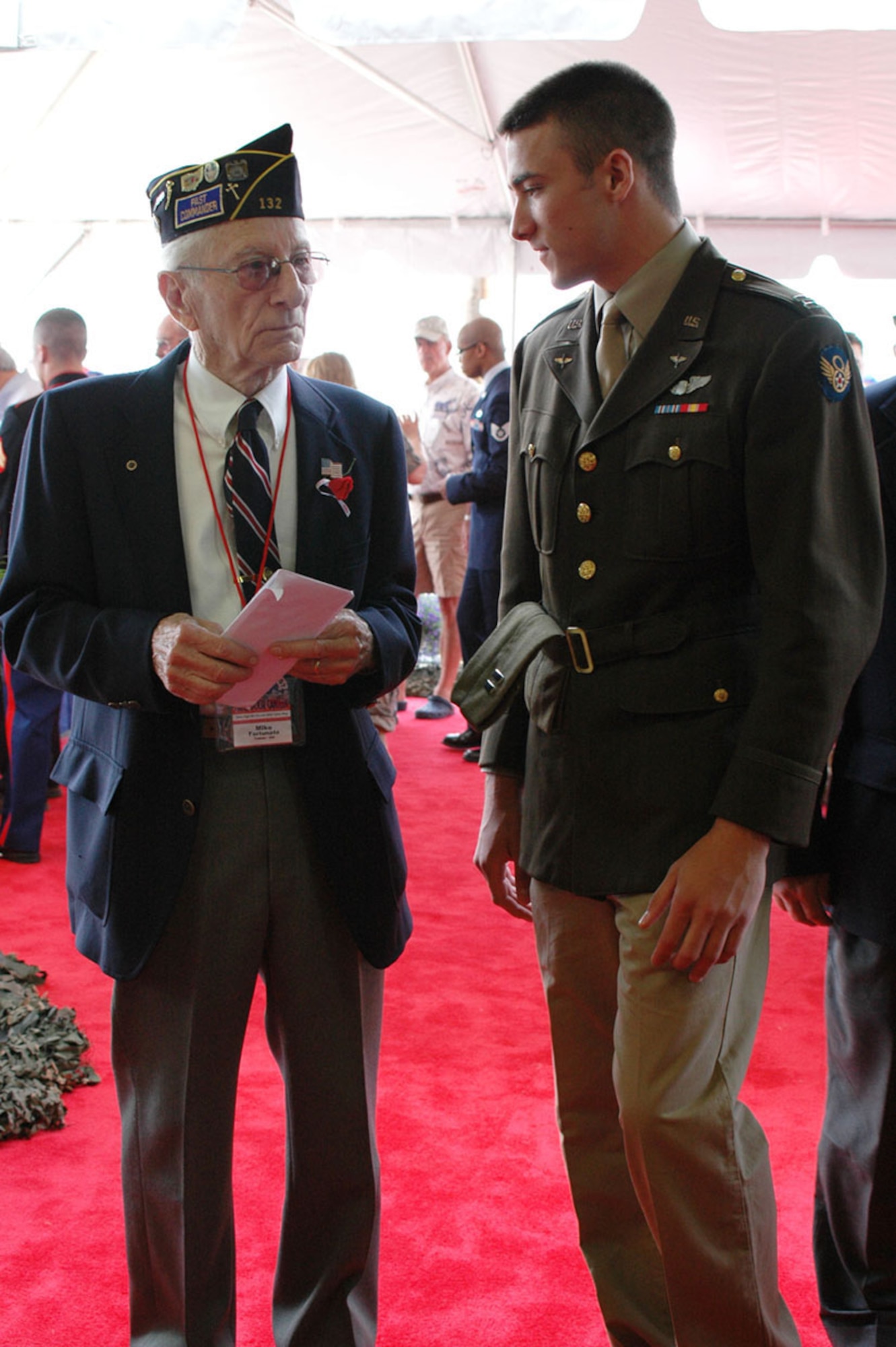 The son of Col. Steven Nordhaus, 180th Fighter Wing Commander, speaks with a World War II veteran at the Stage Door Canteen, hosted by the 180th Fighter Wing and Honor Flight of Northwest Ohio, May 21 at the 180th Fighter Wing.