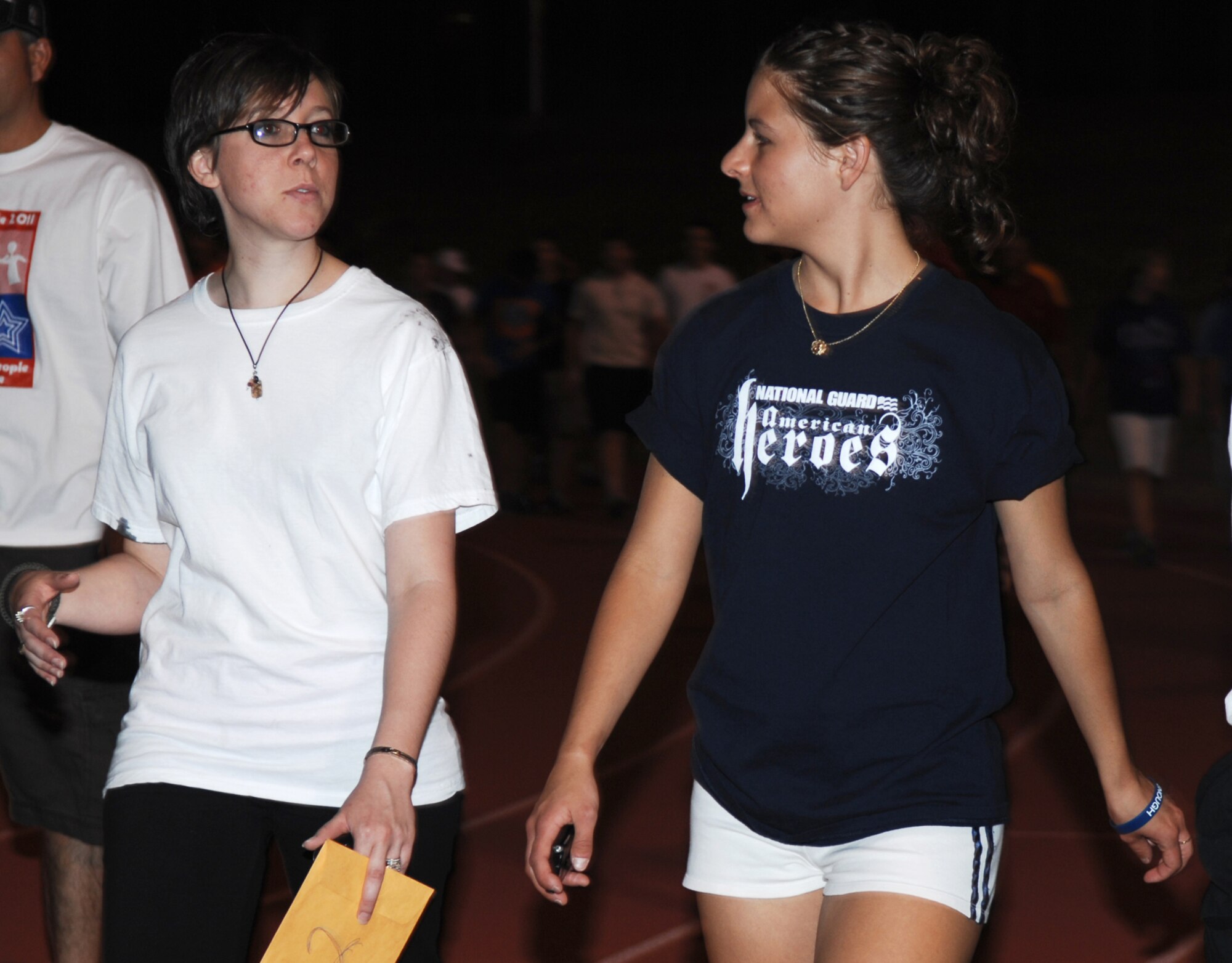 SAN ANGELO, Texas -- Airman 1st Class Cassandra Carley and Brittney Welchon, 17th Force Support Squadron, take a lap around the track during the 2011 Relay for Life of Tom Green County Texas May 20. The event raised approximately $190,000 with more than 1300 participants signed up and many more in attendance. (U.S. Air Force photo/Staff Sgt. Laura R. McFarlane)