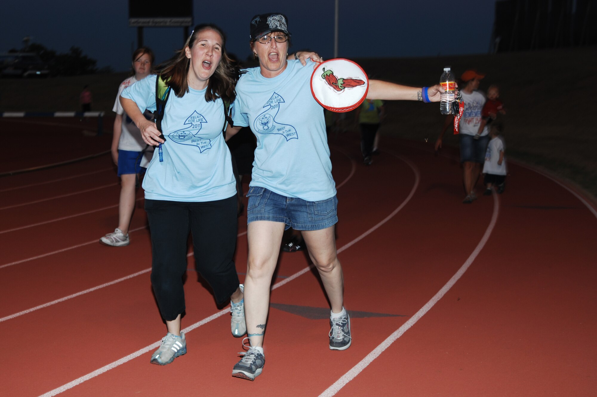 SAN ANGELO, Texas -- Debbie Flynn, wife of Jason Flynn, 315th Training Squadron, walks around the track with Karen Van Etten, 17th Logistics Readiness Squadron, during the 2011 Relay for Life of Tom Green County Texas May 20. The event raised approximately $190,000 with more than 1300 participants signed up and many more in attendance. (U.S. Air Force photo/Staff Sgt. Laura R. McFarlane)