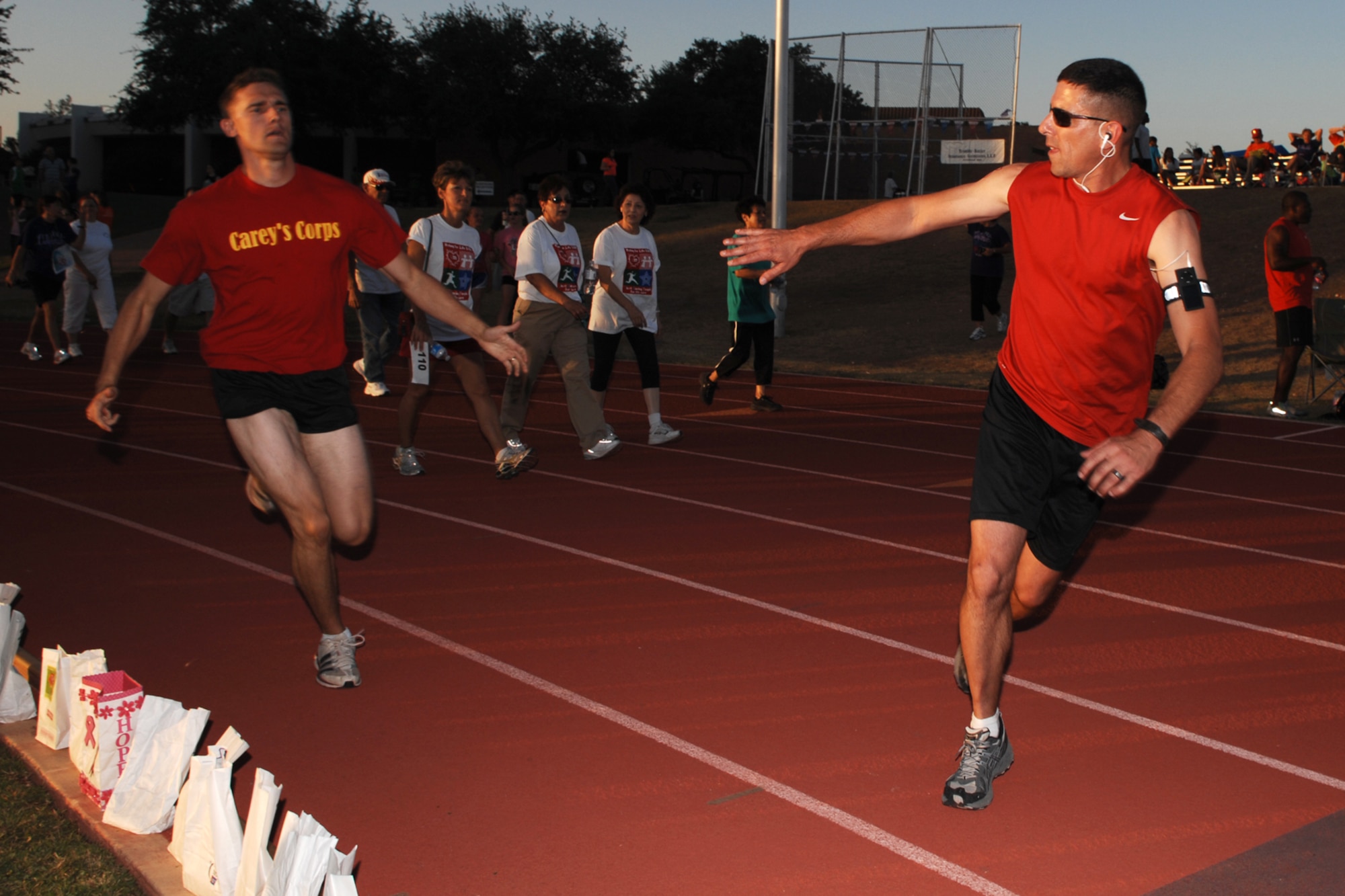SAN ANGELO, Texas -- Marine Corps Chief Warrant Officer Todd Tarker, alternates turns on the track with Marine Corps Sgt. Josh Ley during the 2011 Relay for Life of Tom Green County Texas May 20. Chief Warrant Officer Tarker and Sgt. Ley are assigned to the Marine Corps Detachment, Goodfellow Air Force Base. The event raised approximately $190,000 with more than 1300 participants signed up and many more in attendance. (U.S. Air Force photo/Staff Sgt. Laura R. McFarlane)