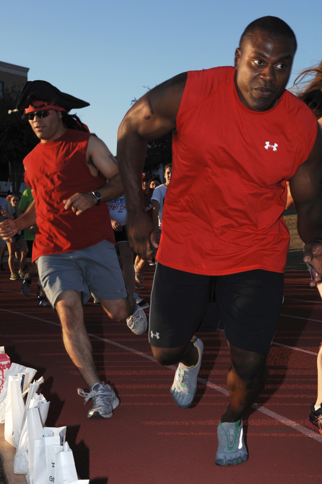 SAN ANGELO, Texas -- Marine Corps Staff Sgts. Pedro Rivera and Adam Slaughter, Marine Corps Detachment, Goodfellow Air Force, alternate turns on the track during the 2011 Relay for Life of Tom Green County Texas May 20. The event raised approximately $190,000 with more than 1300 participants signed up and many more in attendance. (U.S. Air Force photo/Staff Sgt. Laura R. McFarlane)