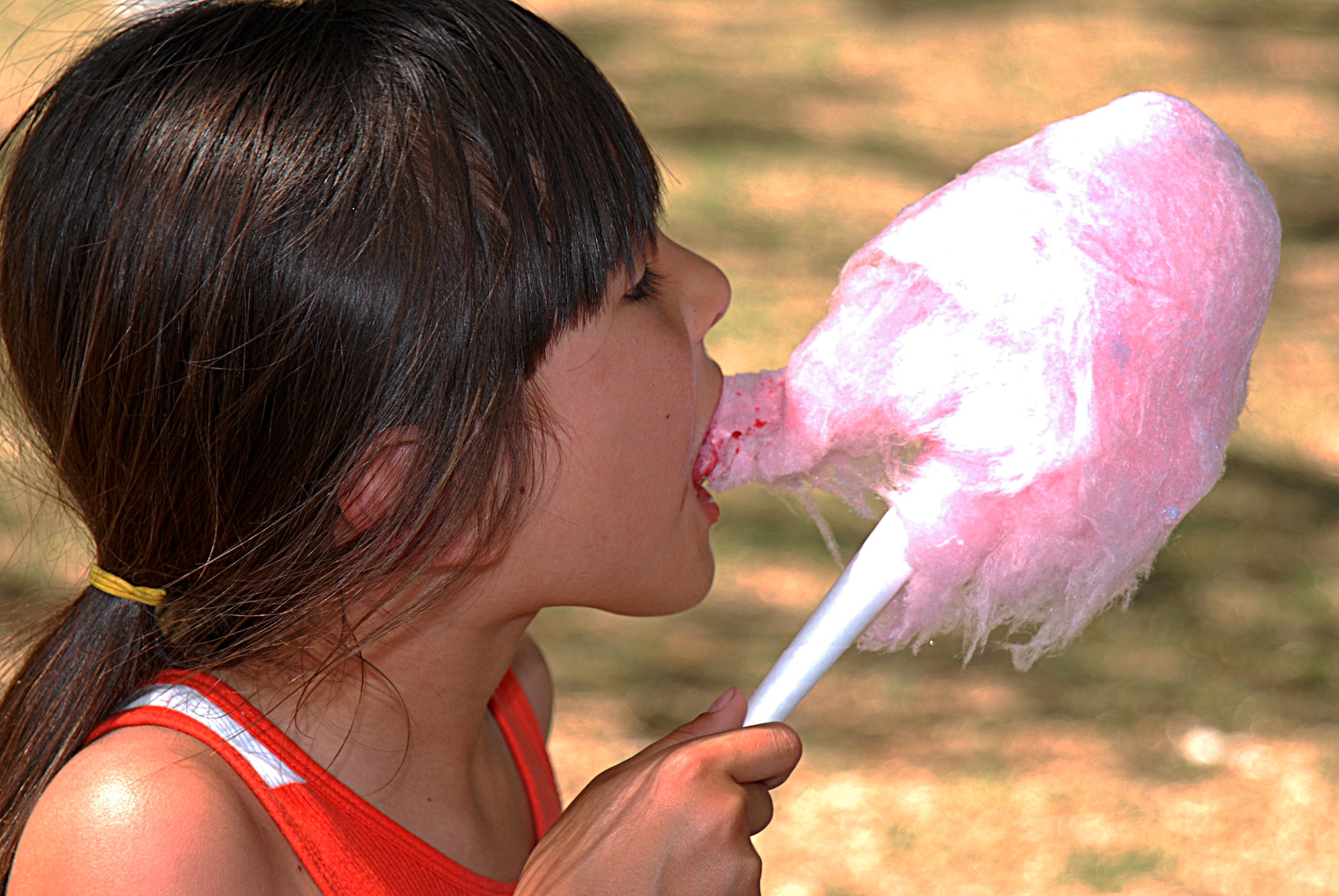 GOODFELLOW AIR FORCE BASE, Texas-- Malayzia Vasquez enjoys freshly made cotton candy at the 6th annual Goodfellow Appreciation Day May 23. The event was sponsored by local businesses and included several events, bungee run, rock climbing, food, drinks and music. (U.S. Air Force photo/Airman 1st Class Michael Smith)