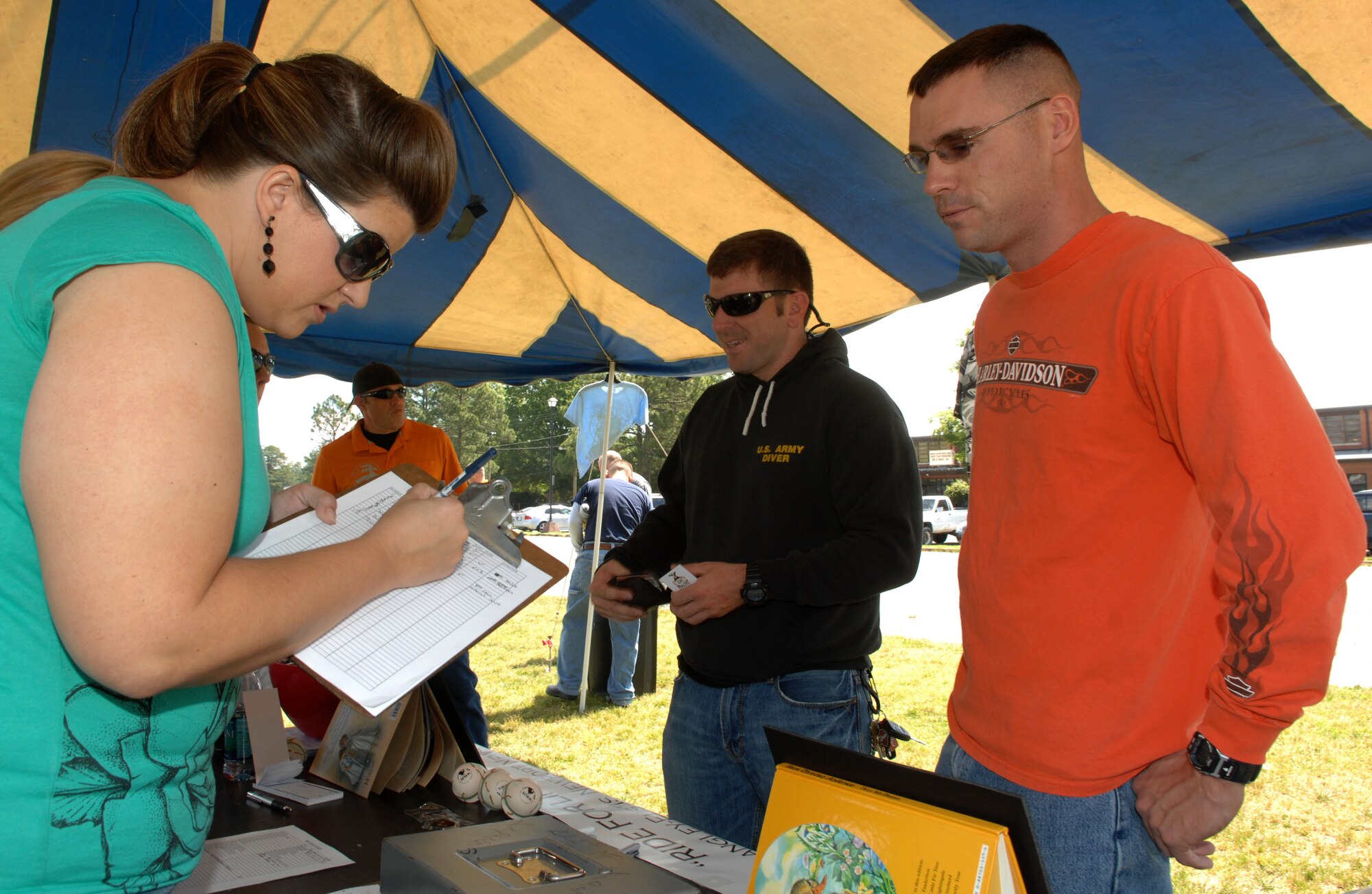Shannon Templeton, 2011 Ride for Life volunteer, assists Navy Seaman Ricky Motley, U.S.S. Winston S. Churchill out of Norfolk Naval Base, with his Ride for Life registration at Fort Eustis, Va., April 20, 2011. Over 70 military members participated, riding their motorcycles throughout York and James County, Va., to support the Wounded Warrior Program and the American Foundation for Suicide Prevention. (U.S. Air Force photo by Staff Sgt. Jeff Nevison) (Released)