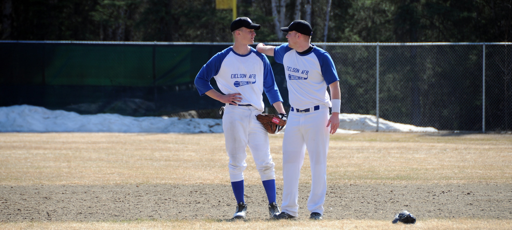 Senior Airman Tyler Highum uses Airman Ryan Bommersbach to stretch his arm during practice May 15, 2011, North Pole, Alaska. The Airmen are on the Iceman baseball team and are part of the Adult Baseball League playing against local teams in Fairbanks and North Pole. Airman Highum is assigned to the 354th Maintenance Squadron munitions flight. Airman Bommersbach is assigned to the 354th Aircraft Maintenance Squadron weapons flight. (U.S. Air Force photo/Senior Airman Rachelle Coleman)