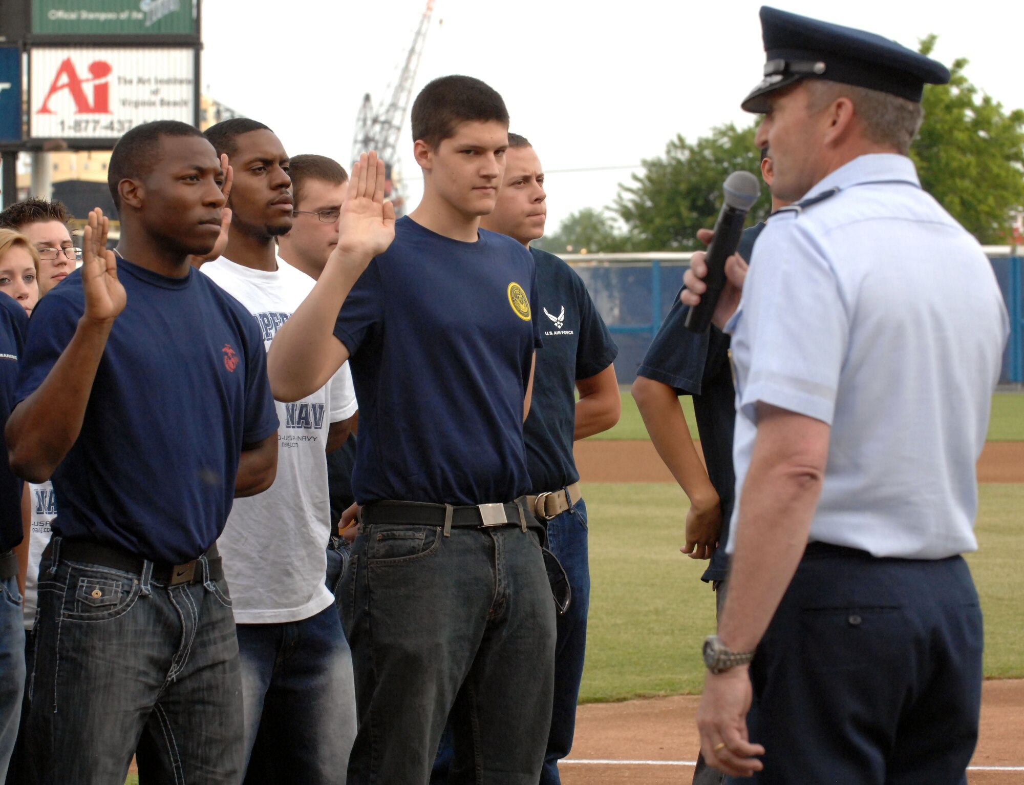 Major Gen. Joseph Reynes  Jr., Headquarters U.S. Joint Forces Command Joint Concept Development and Experimentation director, gives the Oath of Enlistment to future recruits during the Norfolk Tides' Military Appreciation Night Saturday, May 21, 2011 at Harbor Park Stadium in Norfolk, Va. Other events of the night included superior performers from each military branch of service throwing the first pitches to begin the game against the Louisville Bats. (U.S. Air Force photo by Staff Sgt. Jeff Nevison)(Released)