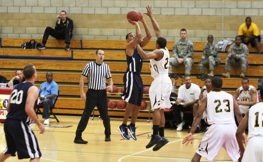 1st. Lt. Matt McCraw, U.S. Air Force Academy, Colo., shoots a jumper past an Army defender during the Armed Forces basketball tournament April 10-18 at Camp Pendleton, Calif. The Air Force men's team defeated the Army  71-65 to win their sixth consecutive championship. (Courtesy photo)