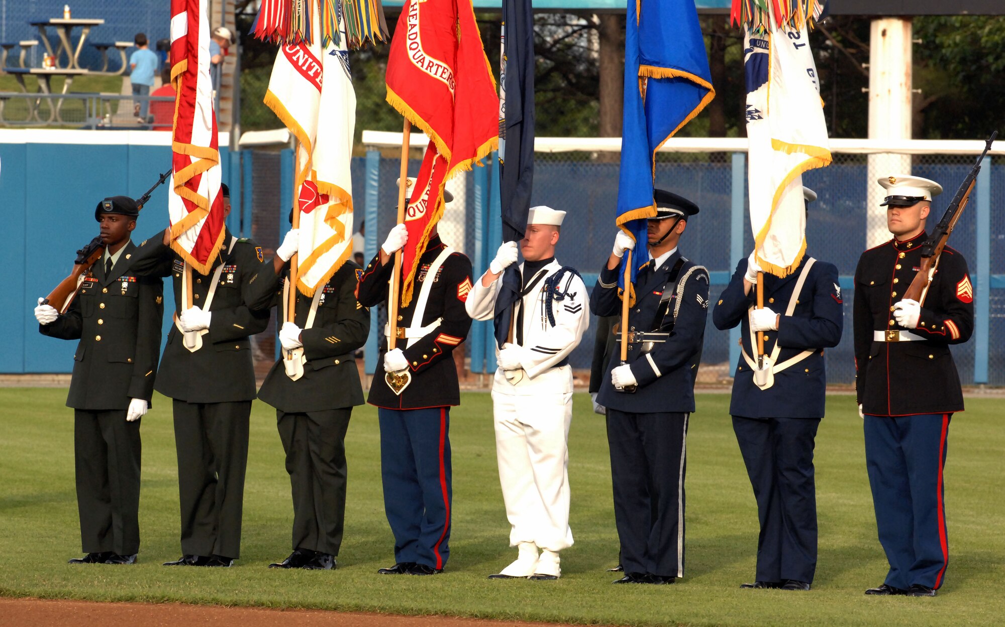 U.S. Joint Service Color Guard marches on field during Norfolk Tides' Military Appreciation Night Saturday, May 21, 2011 at Park Stadium in Norfolk, Va. The night’s events included superior performers from each military branch of service throwing the first pitches to begin the game against the Louisville Bats. (U.S. Air Force photo by Staff Sgt. Jeff Nevison)(Released)
