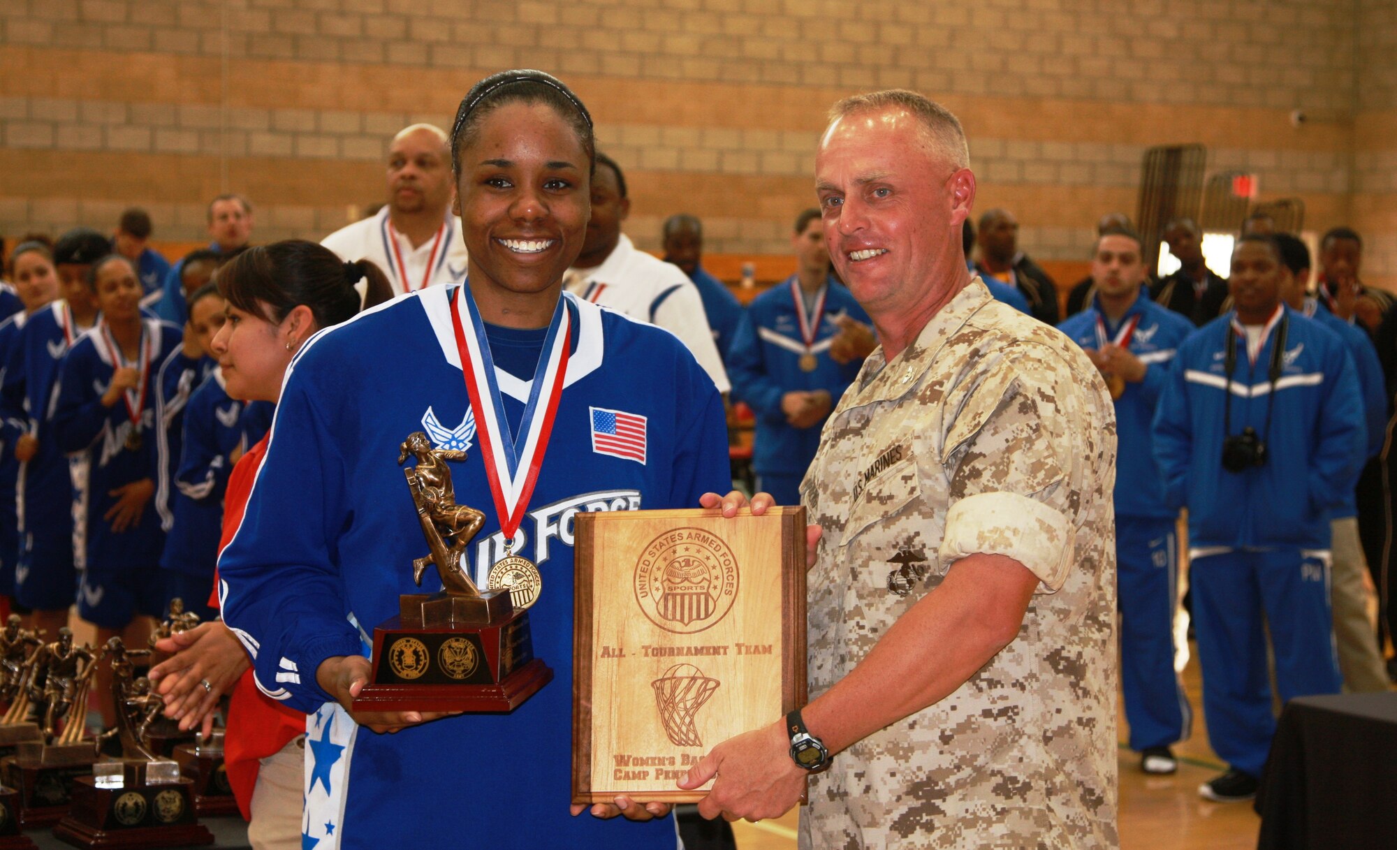 Staff Sgt. Tiffanie Guthrie, Joint Base Elmendorf-Richardson, Alaska, receives her plaque for being selected to the Armed Forces Women's basketball all-tournament team. Sergeant Guthrie and her team won the women's championship title during the annual Armed Forces basketball tournament April 10-18. Acoording to her coach, she was the team's floor leader who commanded attention. (Courtesy photo)