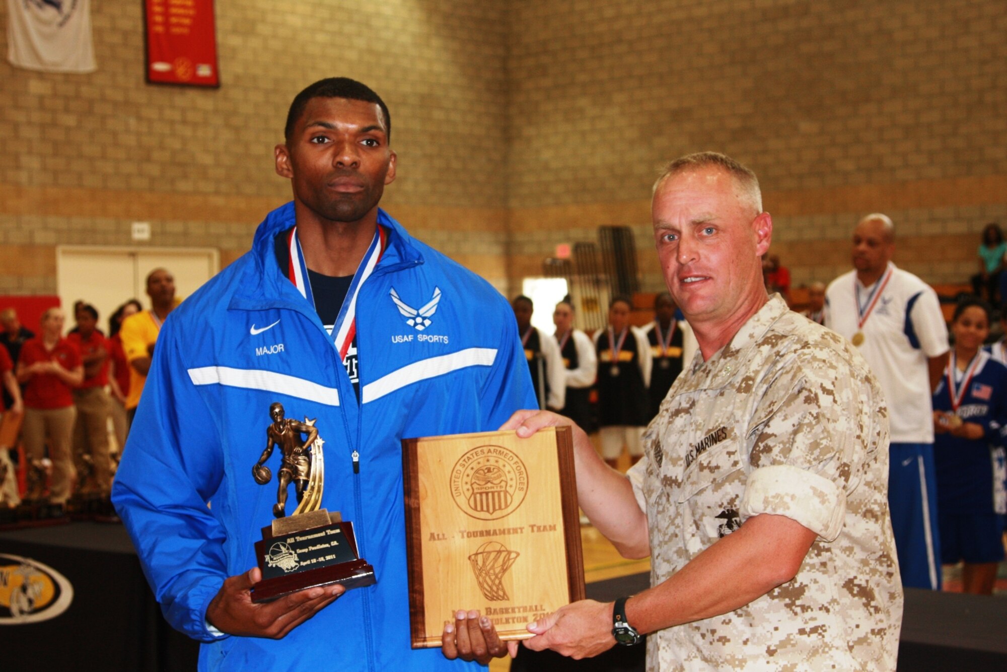 Senior Airman Jammar Major, Hurlburt Field, Fla., receives his plaque for being selected to the Armed Forces Men's basketball all-tournament team. Airman Major and his team won the championship title during the annual Armed Forces basketball tournament April 10-18. Acoording to his coach, Airman Major was the most dominant player on the Air Force men's basketball team. (Courtesy photo)