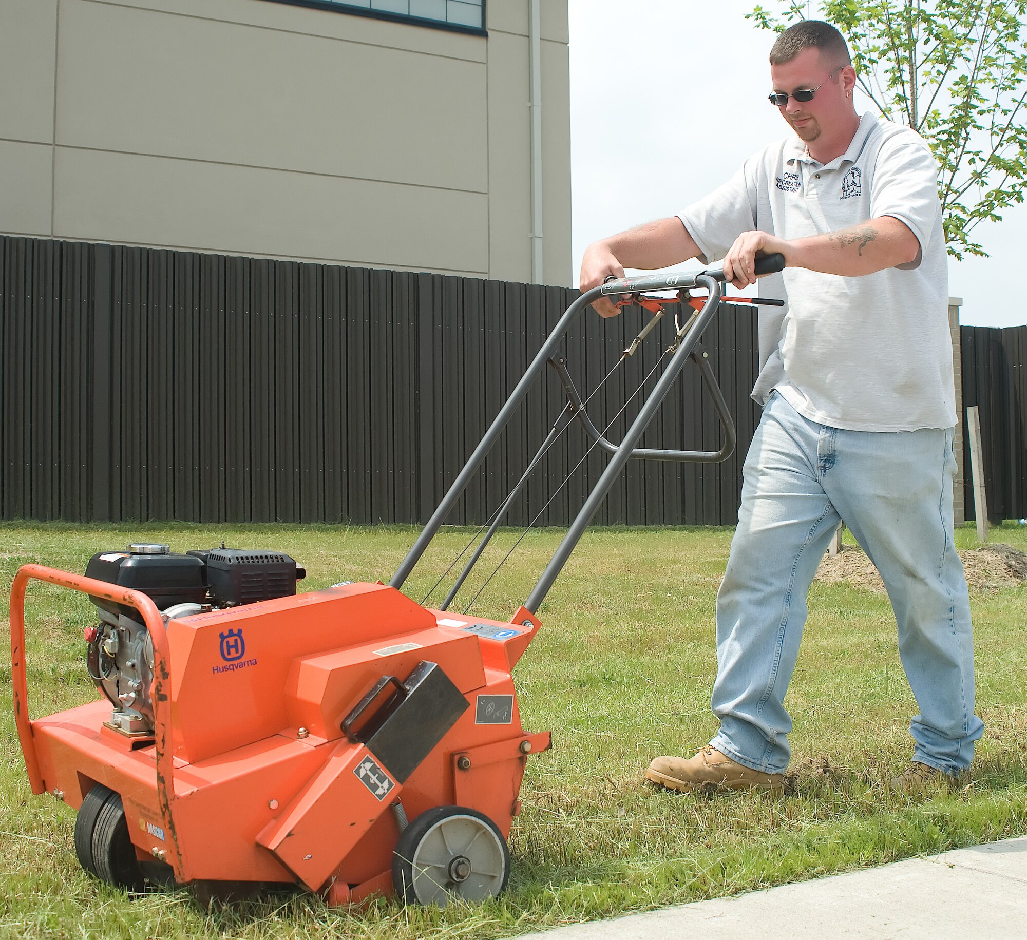 Chris Rosebrooks, 436th Force Support Squadron recreation assistant, demonstrates how to use an aerating machine May 23, 2011 at Dover Air Force Base, Del. With summer approaching, Mr. Rosebrooks has been making sure all the equipment runs properly.  (U.S. Air Force photo by Adrian Rowan)