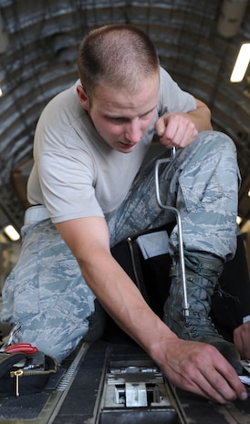Senior Airman Aaron Jagow cleans and inspects the tow release mechanism on the ramp of a C-17 during a Home Station Check inspection on Joint Base Charleston - Air Base, May 23. HSC is a three-day inspection performed every 120 days. Airman Jagow is a member of the HSC department of the 437th Maintenance Squadron. (U.S. Air Force photo/ Staff Sgt. Nicole Mickle)  