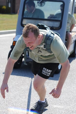 Maj. Timothy Huxel, a member of the Monster Mash team "Hammer Time", pulls a mule around a parking lot on Joint Base Charleston - Air Base, May 19. The Monster Mash is 3.1 miles long and includes six challenging obstacles including a wall climb, truck push, mule pull, litter carry, jersey tug, and tire flip. The Monster Mash was hosted by the 437th Operations Support Squadron. Major Huxel is an evaluator from the 437th Operations Group.  (U.S. Air Force photo/ Staff Sgt. Nicole Mickle