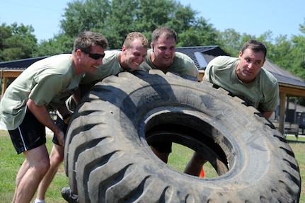 Members of the Monster Mash team "Hammer Time" work together to flip a tire to finish the Monster Mash at the base picnic grounds on , Joint Base Charleston - Air Base, May 19.  The Monster Mash event is 3.1 miles long and includes six challenging obstacles including a wall climb, truck push, mule pull, litter carry, jersey tug, and tire flip. The Monster Mash was hosted by the 437th Operations Support Squadron. The "Fuhrballs" from the 437th Operations Support Squadron beat out six other teams to claim bragging rights. (U.S. Air Force photo/ Staff Sgt. Nicole Mickle)  
