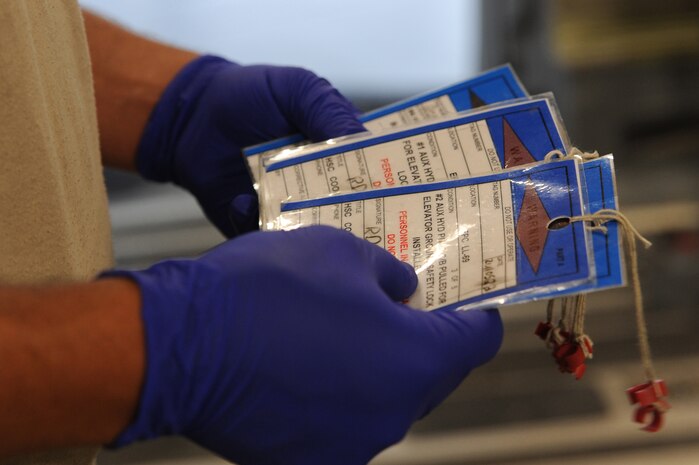 Staff Sgt. Adam Hall examines warning tags during a Home Station Check inspection on a C-17 at Joint Base Charleston - Air Base, May 23. HSC is a three-day inspection performed every 120 days. Sergeant Hall is assigned to the HSC department of the 437th Maintenance Squadron. (U.S. Air Force photo/ Staff Sgt. Nicole Mickle)  