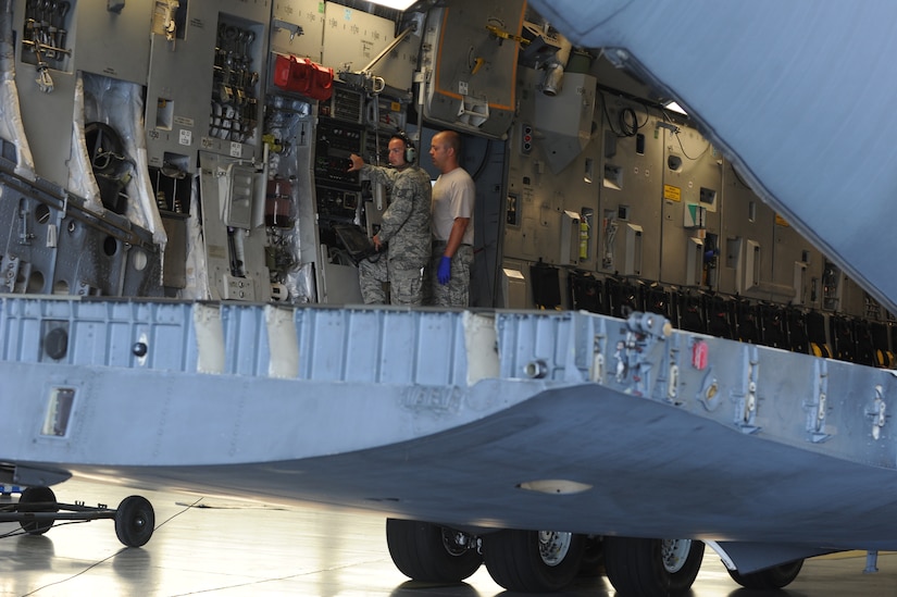 Staff Sgt. Daniel Weil and Staff Sgt. Adam Hall  open the ramp on a C-17 during a Home Station Check inspection on Joint Base Charleston - Air Base, May 23.  HSC is a three-day inspection performed every 120 days. The inspection enables ground crews to perform preventive maintenance if needed. Sergeant Weil and Sergeant Hall work in the HSC department of the 437th Maintenance Squadron.  (U.S. Air Force photo/ Staff Sgt. Nicole Mickle)