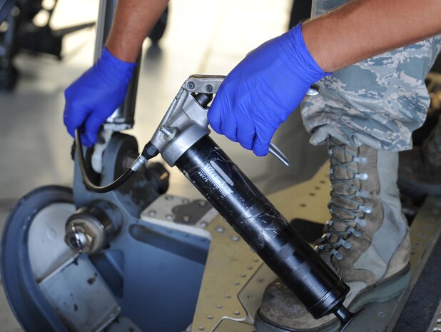 Staff Sgt. Adam Hall applies grease to a fitting on the cargo ramp actuator during a Home Station Check inspection of a C-17 on Joint Base Charleston - Air Base, May 23. HSC is a three-day inspection performed every 120 days. Sergeant Hall works for the HSC department of the 437th Maintenance Squadron.  (U.S. Air Force photo/ Staff Sgt. Nicole Mickle)