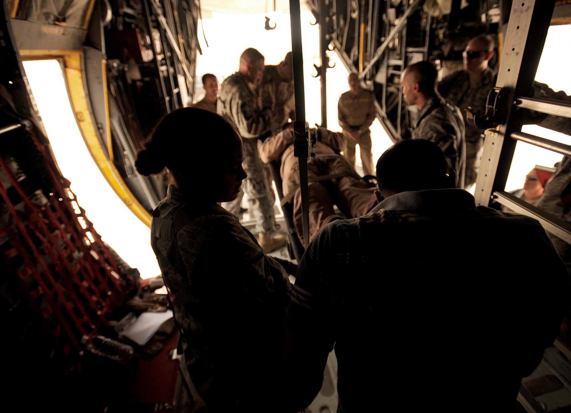 NEW AL-MUTHANA AIR BASE, Iraq -- U.S. Air Force Master Sgt. Dejnekki Peyton, left, Iraq Training and Advisory Mission - Air independent duty medical technician, helps her Iraqi counterparts secure a litter to stanchions inside an Iraqi air force C-130 Hercules during a two-day aeromedical evacuation training session with six Iraqi medics. The Iraqi air force medics were presented with training certificates after completing training with three U.S. Air Force and Army units from CampTaji, Joint Base Balad and Sather Air Base. Sergeant Peyton is deployed from Creech Air Force Base, Nev., and hails from Detroit, Mich. (U.S. Air Force/Tech. Sgt. Jason Lake)