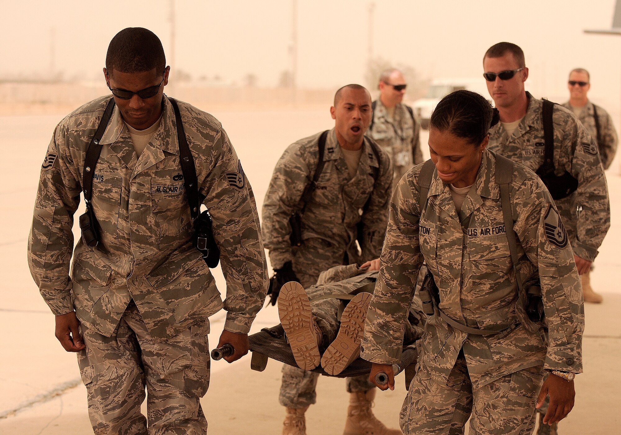 NEW AL-MUTHANA AIR BASE, Iraq -- U.S. Air Force Capt. Reggie Brown, center, 332nd Expeditionary Medical Group critical care nurse, calls out commands as Airmen demonstrate a four-man litter carry to their Iraqi air force counterparts May 19. Six Iraqi medics learned the basics of aeromedical evacuation over two days with U.S. Air Force and Army advisors from three bases. The medics learned about medical evacuation capabilities of various aircraft brought in for the class including the UH-60 Blackhawk, Mi-171 Hip and UH-1 Huey helicopters, as well as a C-130 Hercules. Captain Brown is deployed from Eglin Air Force Base, Fla., and hails from Long Island, N.Y. (U.S. Air Force/Tech. Sgt. Jason Lake)