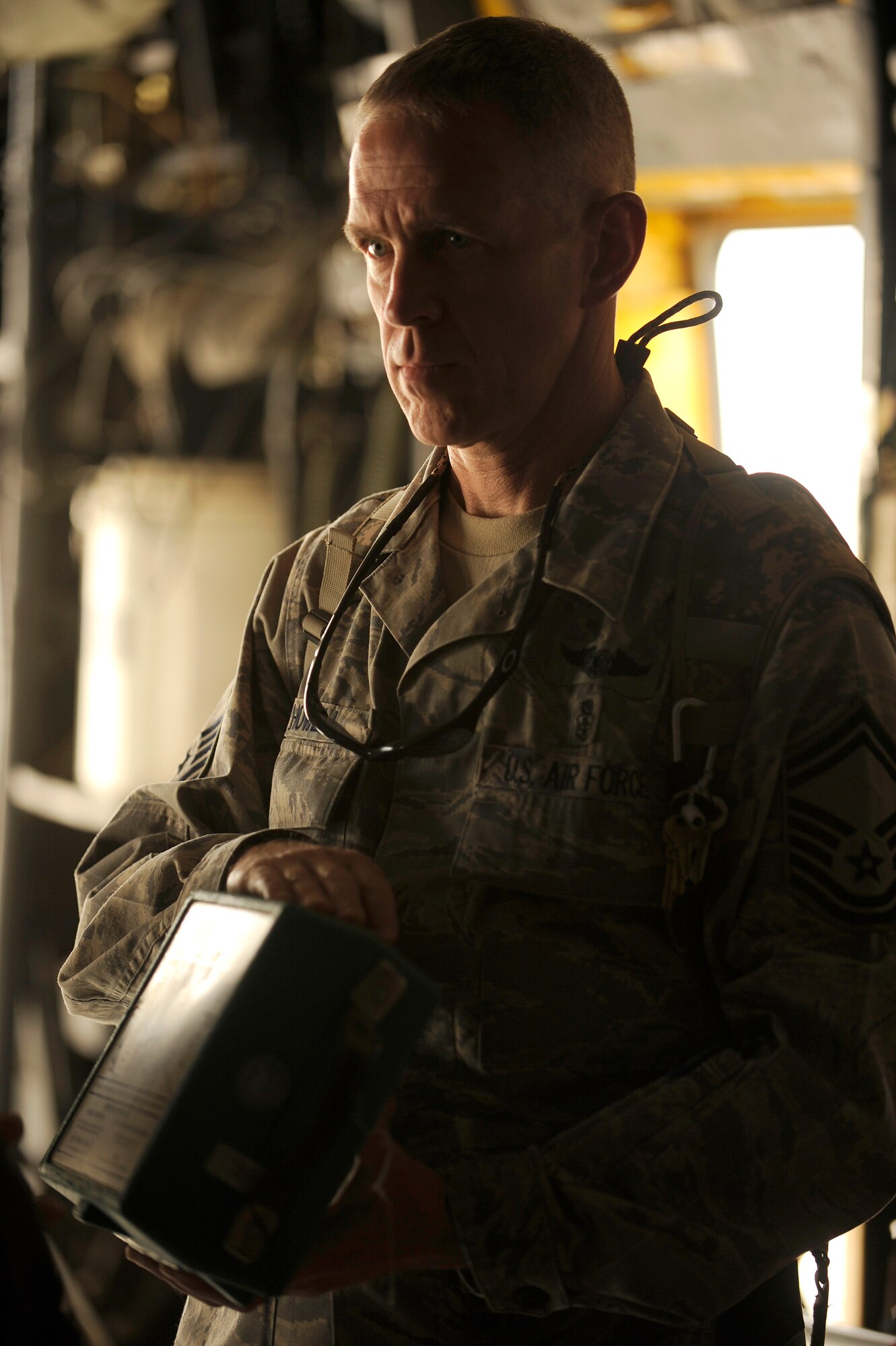 NEW AL-MUTHANA AIR BASE, Iraq -- Senior Master Sgt. Marvin Howell, 332nd Expeditionary Medical Operations Squadron superintendent, shows Iraqi air force medics the emergency personal oxygen system during training inside an Iraqi C-130 Hercules May 19. U.S. Air Force and Army units from three bases converged here for a two-day aeromedical evacuation training session with six Iraqi air force medics. Sergeant Howell is deployed from Lackland Air Force, Texas, and calls Suffolk, Va., his home. (U.S. Air Force/Tech. Sgt. Jason Lake)