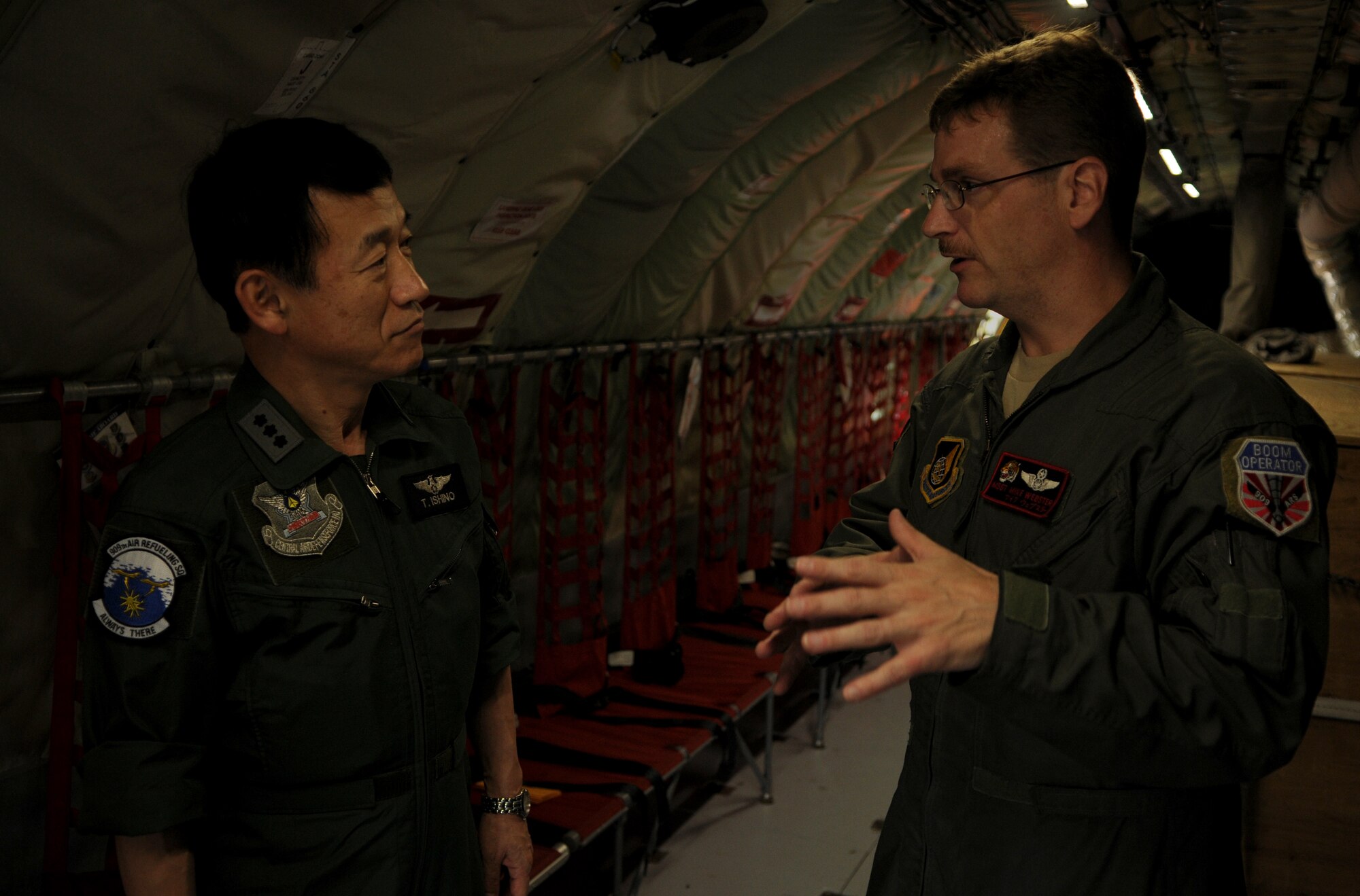 Master Sgt. Mike Webster, an in-flight refueling technician with the 909th Air Refueling Squadron, gives  Lt. Gen. Tsugio Ishino, the Central Air Defense Force commander for the Japan Air Self Defense Force, a pre-flight briefing aboard a KC- 135 Stratotanker aircraft at Kadena Air Base, Japan, May 24. This unique opportunity allowed general Ishino to see air refueling operations between Japan and U.S. aircraft and personnel. (U.S. Air Force photo/Airman 1st Class Jarvie Z. Wallace)