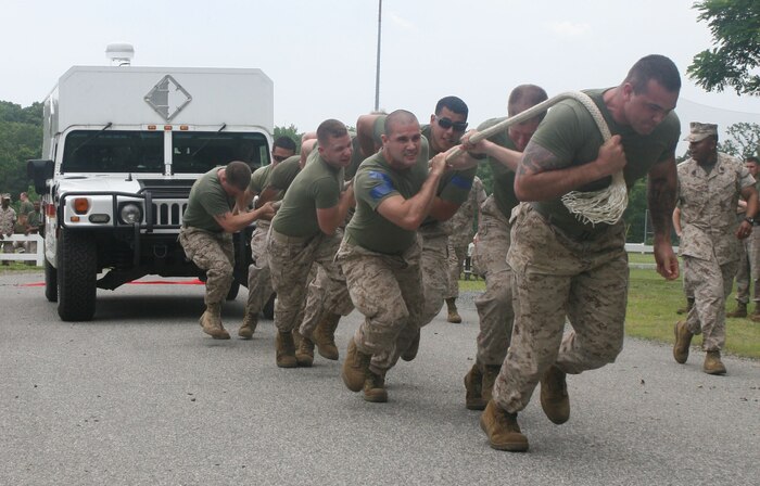 Marines from Initial Response Force B, React Company, Chemical Biological Incident Response Force, charge forward to take first place in the truck pull during CBIRF’s battalion field meet 24 May. Headquarters and Support Company, IRF A and IFR B all competed against one another in several events to strengthen unit cohesion after the safety brief before the Memorial Day weekend.